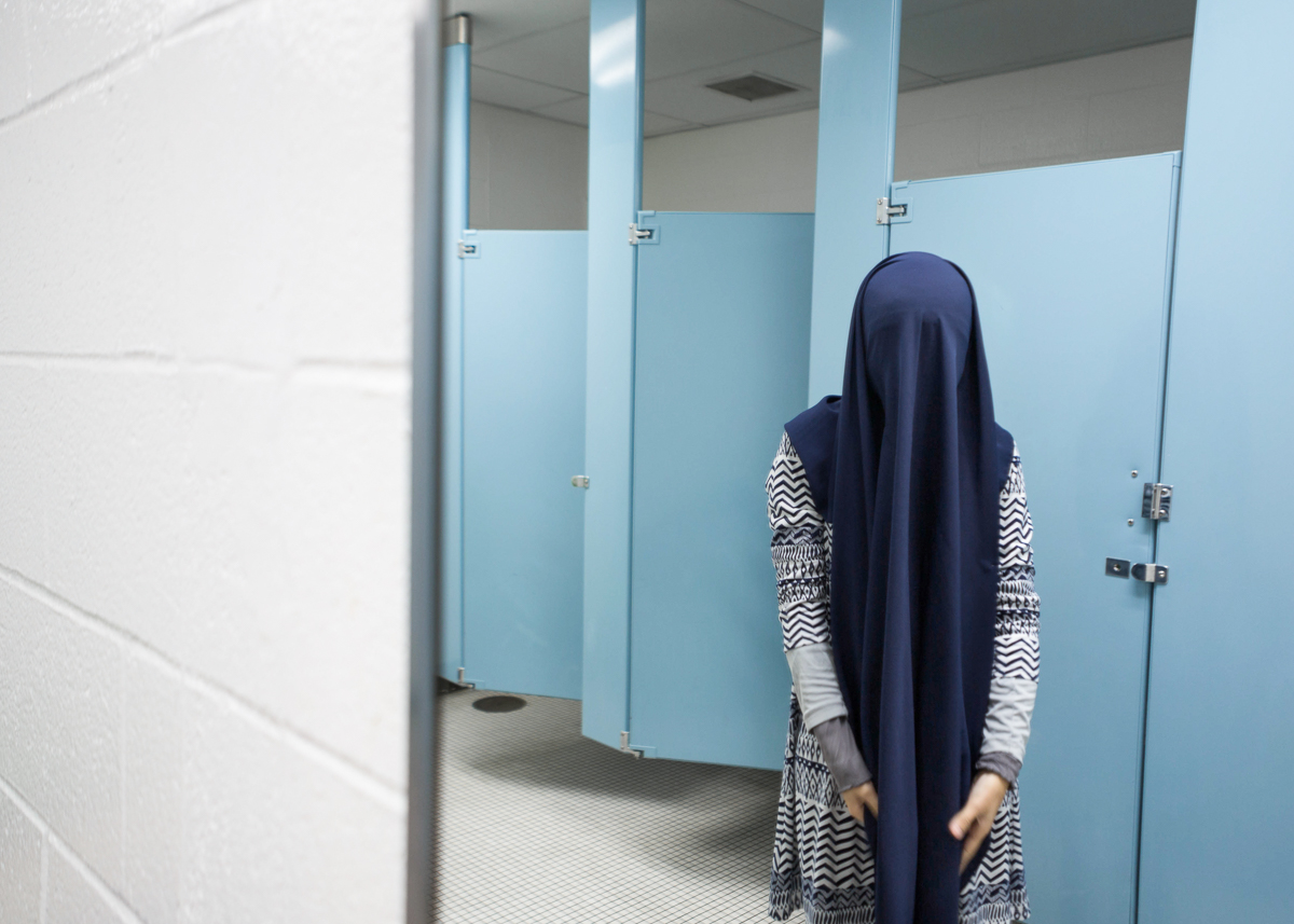 Fatini re-veils her hijab before finding a place to pray in between her classes. Dec 4, 2013.