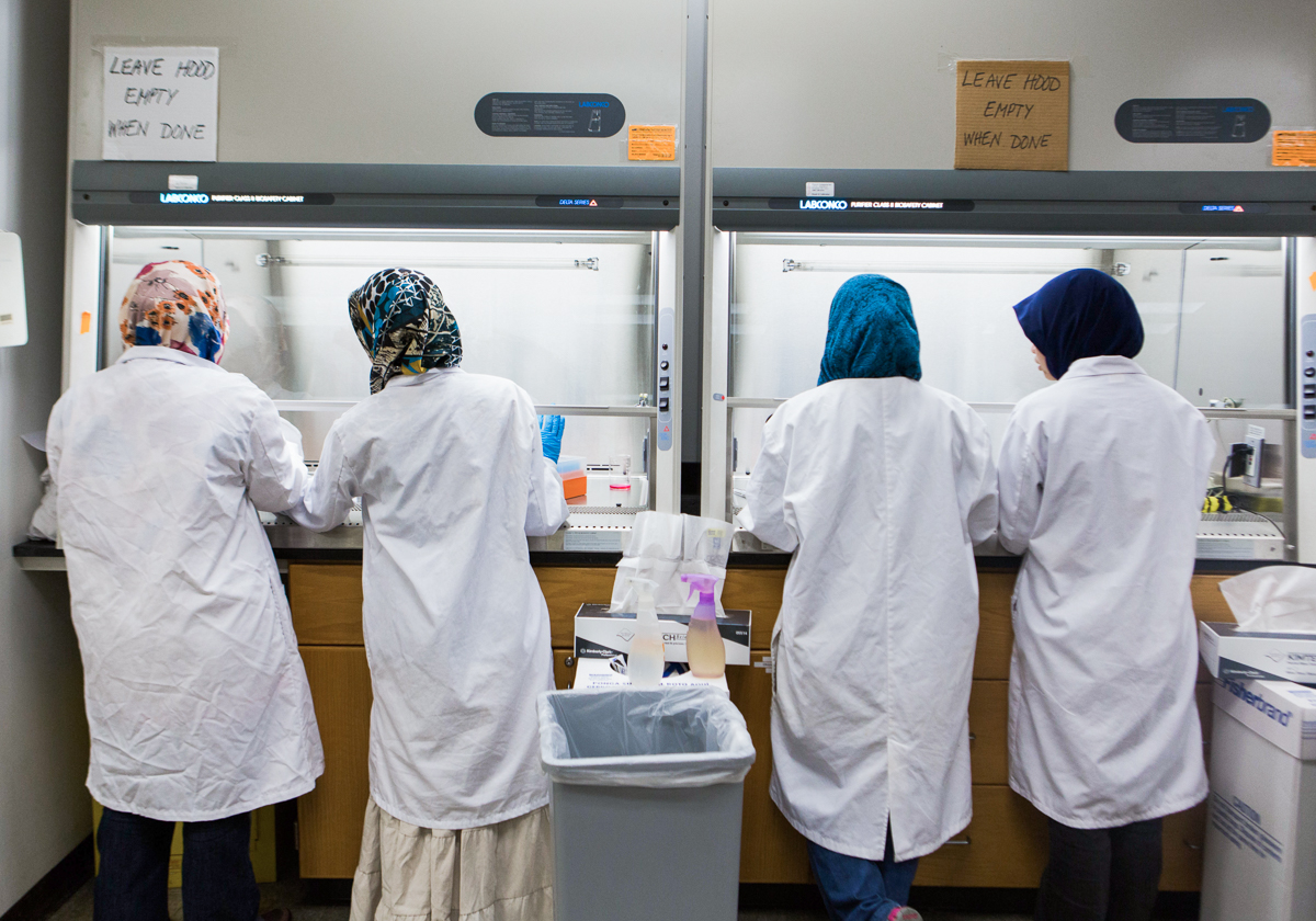 Every year a small group of Malaysian women arrive at the Rochester Institute of Technology on government scholarships from their country to earn degrees in biotechnology. The women prepare for the lab in their “Tissue Cultures” class at the College of Science at Rochester Institute of Technology (RIT) on Dec 4, 2013. Left to right : Aiman Rosdi, Norazleen Hashim, Kilala Rahman, and Fatini Busairi