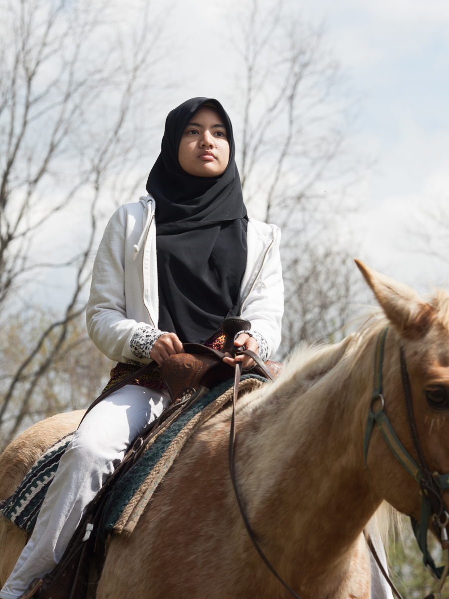 Noralzeen Hashim rides horseback during her wellness class in Avon, New York. May 10, 2014.