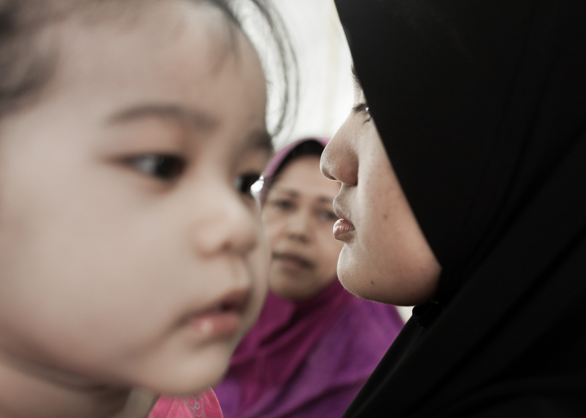Norazleen Hashim holds her niece, Adelia while shopping with her mother in Klang, Selangor, Malaysia on Aug 8, 2014.