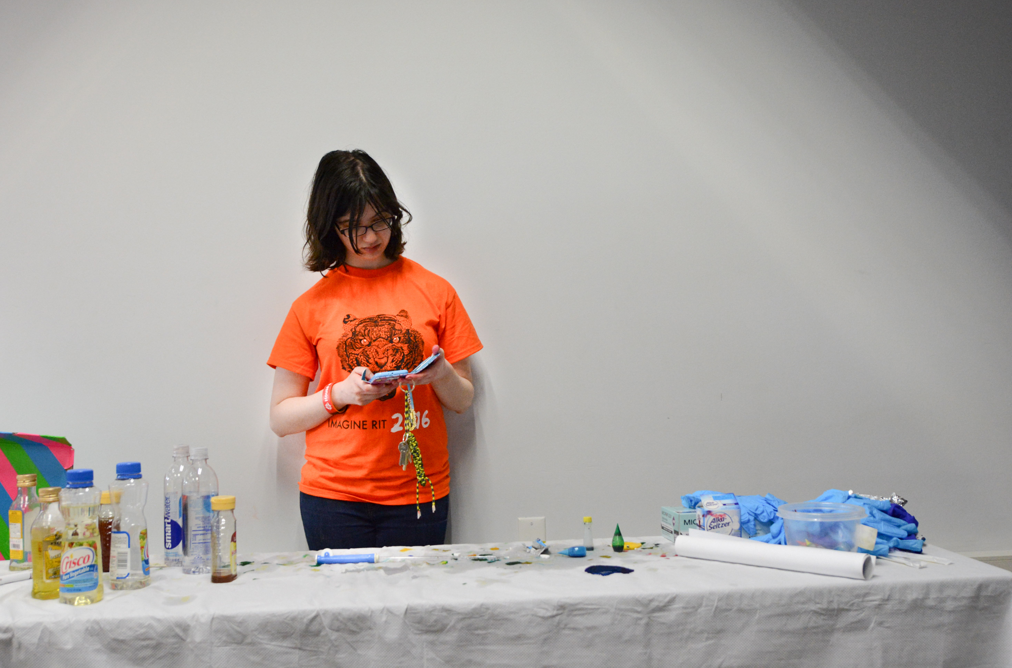 Hahah Berga, a second year Biology student, waits for new supplies for her liquid classification demonstration, during Imagine RIT: Innovation and Creativity Festival on the Rochester Institute of Technology campus in Rochester, N.Y., May 7, 2016. (Photo by Boris Shirman) #imaginerit #ritpj