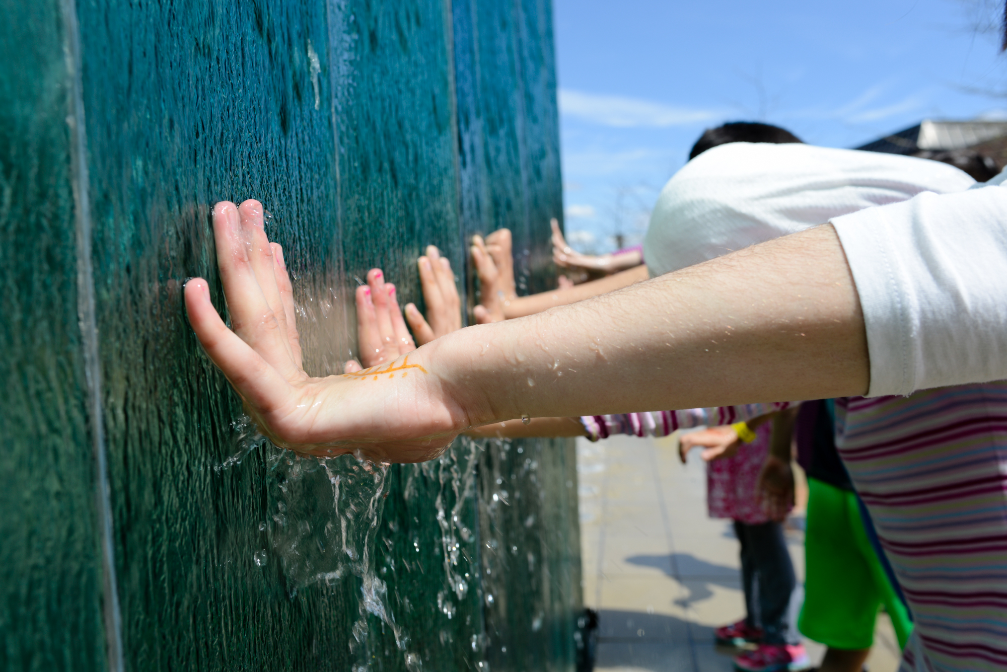 Children hold their hands up to a fountain in global village during Imagine RIT: Innovation and Creativity Festival on the Rochester Institute of Technology campus in Rochester, N.Y., May 7, 2016. (Photo by Jackie Molloy) #imaginerit #ritpj
