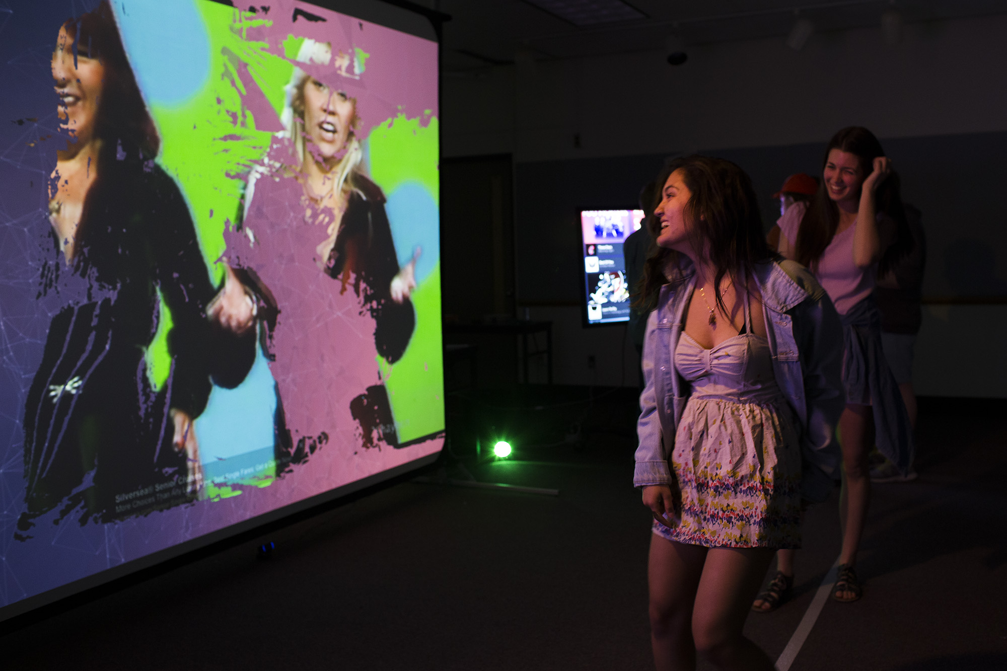 Ferret Shaukat (left), a fourth year Visual Media student, and Chelsea Clarke (right), a fourth year Advertising Photography student, dances in front of s screen to reveal an image as part of the Evoxe exhibit during Imagine RIT: Innovation and Creativity Festival on the Rochester Institute of Technology campus in Rochester, N.Y., May 7, 2016.  #imaginerit #ritpj