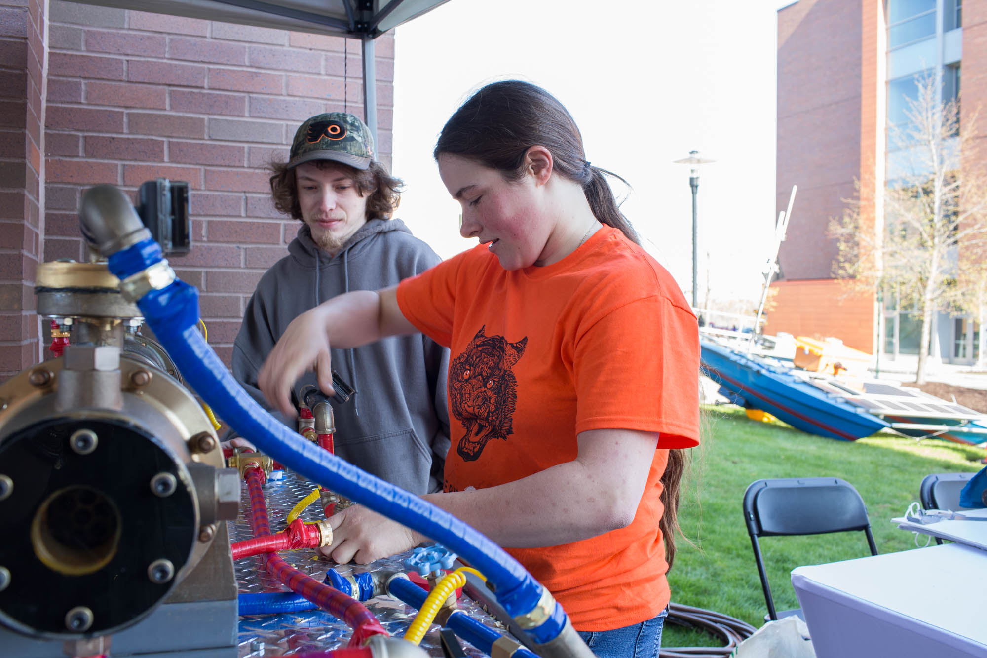 Sarah Kirk, a 4th year Mechanical Engineering and Environmental Science major, and Maxx Frysinger, an electrical contractor, work to set up a heat exchanger during Imagine RIT: Innovation and Creativity Festival on the Rochester Institute of Technology campus in Rochester, N.Y., May 7, 2016. (Photo by Emily Hunt) #imaginerit #ritpj