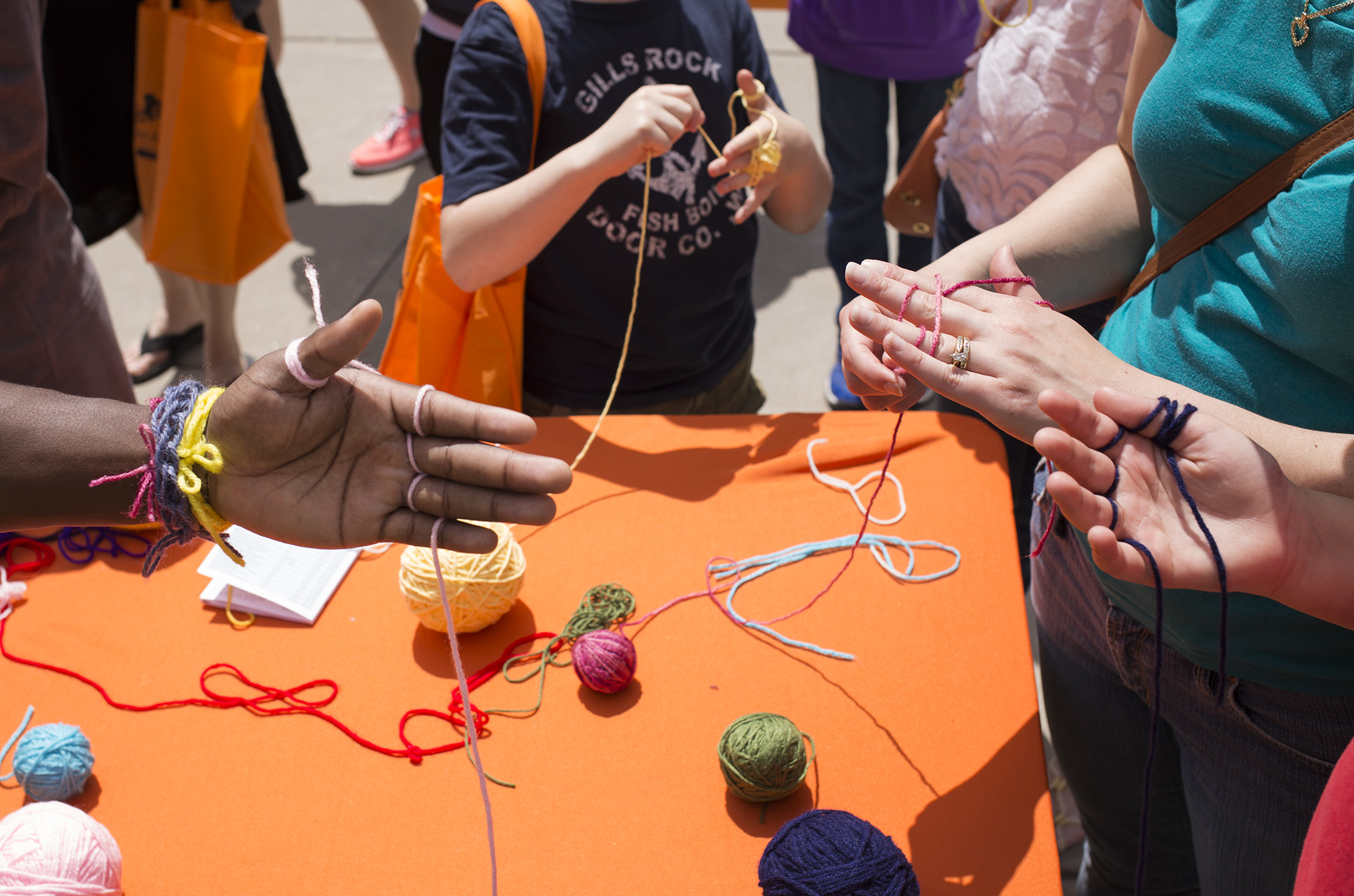 Hooks and Needles, RIT's knitting and crochet club, teaches visitors to make necklaces by hand during Imagine RIT: Innovation and Creativity Festival on the Rochester Institute of Technology campus in Rochester, N.Y., May 7, 2016. (Photo by Joey Ressler) #imaginerit #ritpj