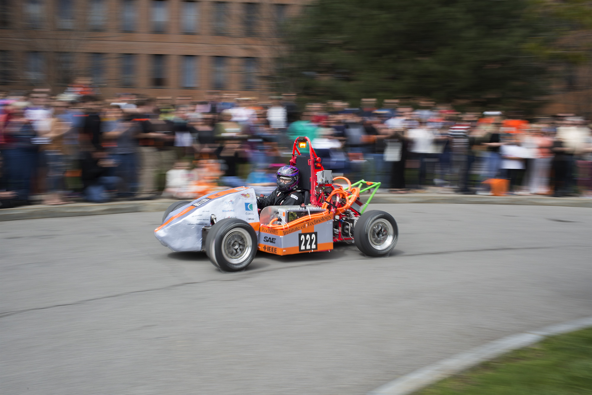 The RIT Formula SAE car drives laps around Simone Circle during Imagine RIT: Innovation and Creativity Festival on the Rochester Institute of Technology campus in Rochester, N.Y., May 7, 2016. (Photo by Tom Brenner) #imaginerit #ritpj