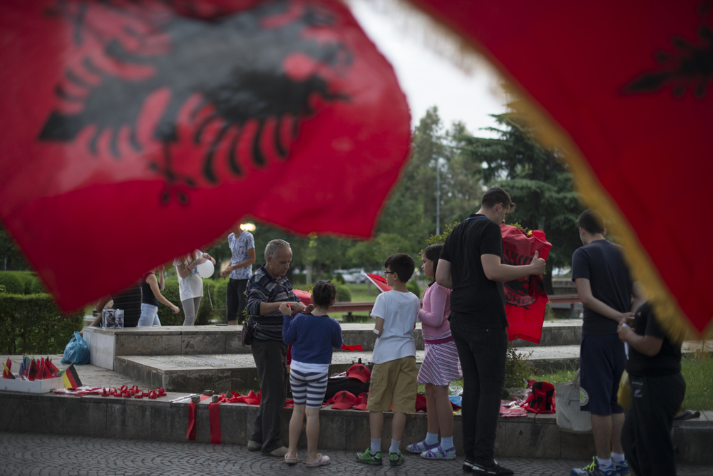 Albanian soccer fans purchase apparel and accessories for the match against Romania in Tirana, Albania on June 19, 2016. 