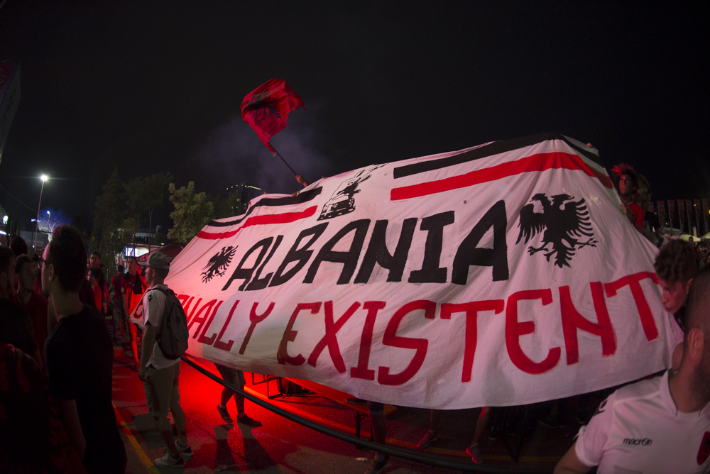 Albanian soccer fans lift a banner reading "Albania, Eternally Existent" the Group A match against Romania in Tirana, Albania on Sunday June 19, 2016. Albania defeated Romania 1-0. 