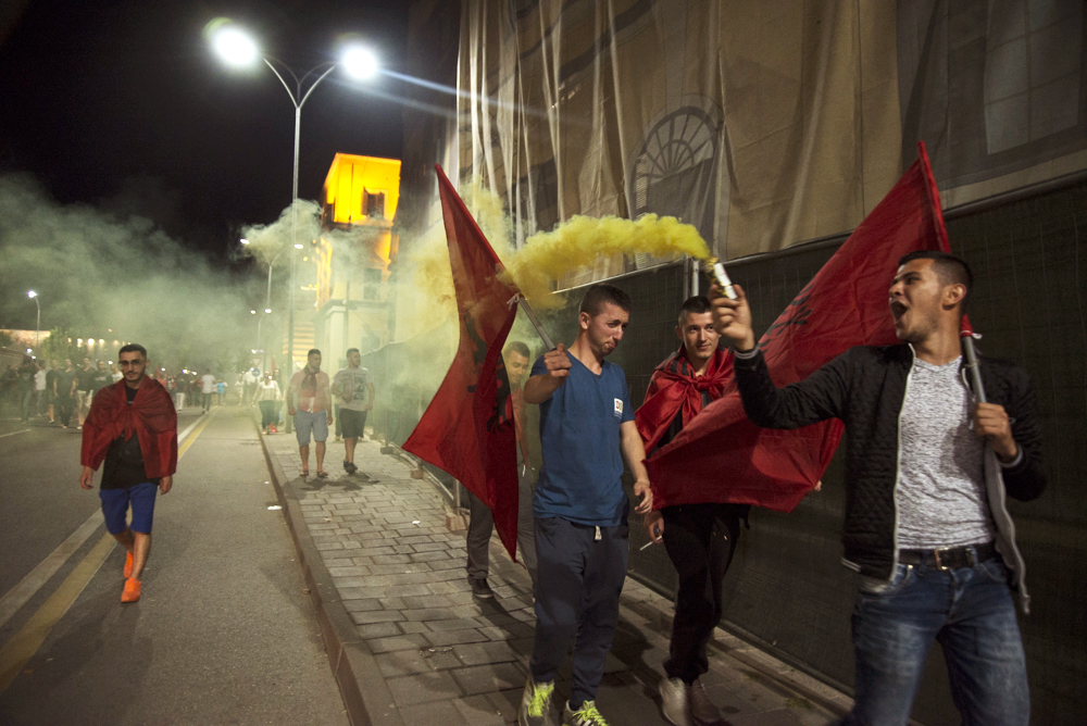 Albanan soccer fans celebrates after their country won the Group A match against Romania in Tirana, Albania on Sunday June 19, 2016. Albania defeated Romania 1-0. 