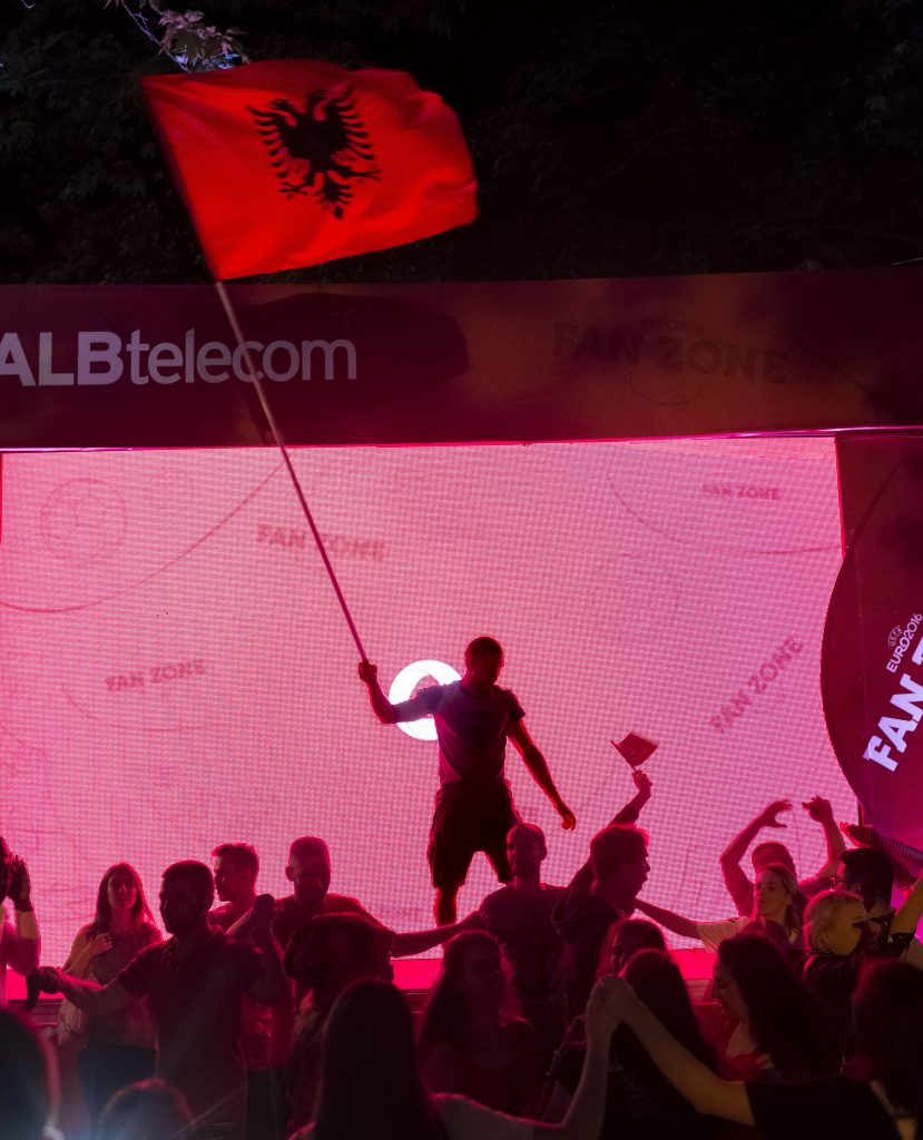 A man waves the Albanian flag in celebration of Albania's victory over Romania in the European Championship in football. Albania defeated Romania 1-0.