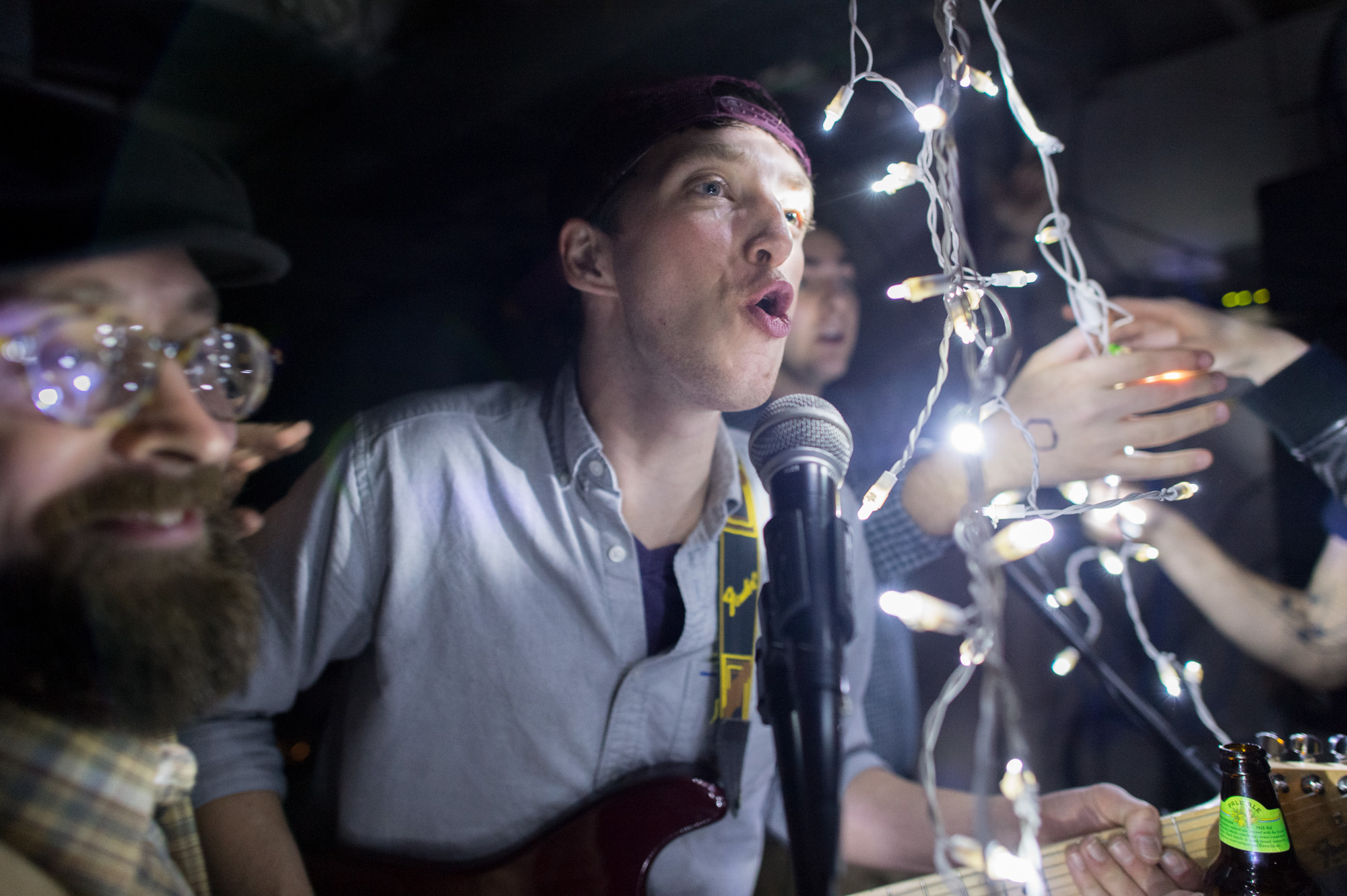 Robb Carr (center), guitarist of Rochester, N.Y. band Buckets, sings before the start of a basement show in downtown Rochester on November 11, 2012.