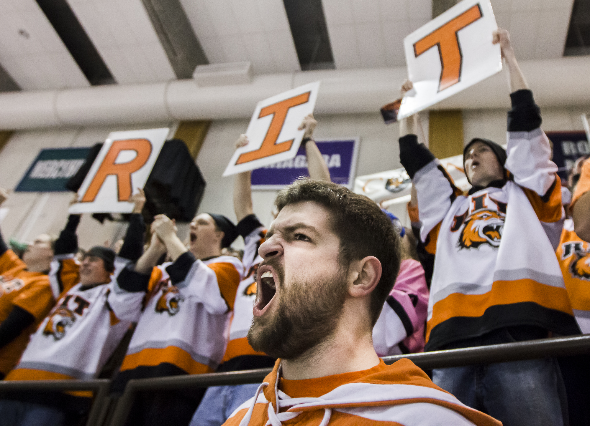 Rochester Institute of Technology Student Ryan Kinney (center) of Boston, Massachusetts cheers on the Men's Ice Hockey team in the final minutes of a game versus Bentley University.  The Tigers shutout Bentley 4-0.