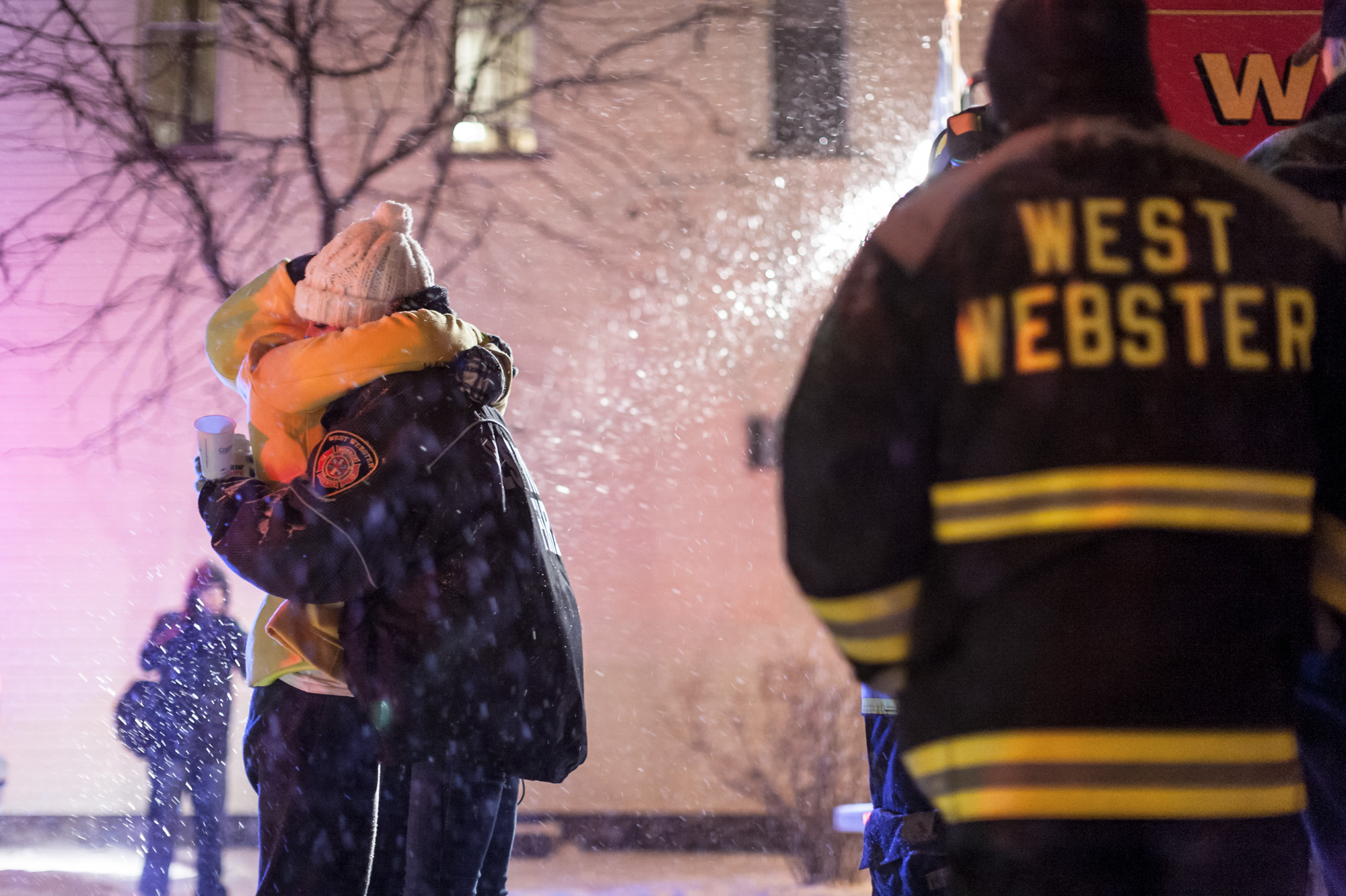 [POTW Weeks 4-5, First place] In Webster, NY, a West Webster firefighter receives an embrace upon arriving at a vigil held for two West Webster volunteer firefighters, Tomasz Kaczowka, a 911 dispatcher in his early 20s, and Michael Chiapperini, a 43-year-old lieutenant with the Webster Police Department, December 26, 2012. After arriving at a car fire which set ablaze seven homes on Lake Rd, both men were killed after being shot at on the morning of Christmas Eve by 62 year old William Spengler. The vigil was organized by the owners of Barry's Old School Irish restaurant on Main Street in Webster