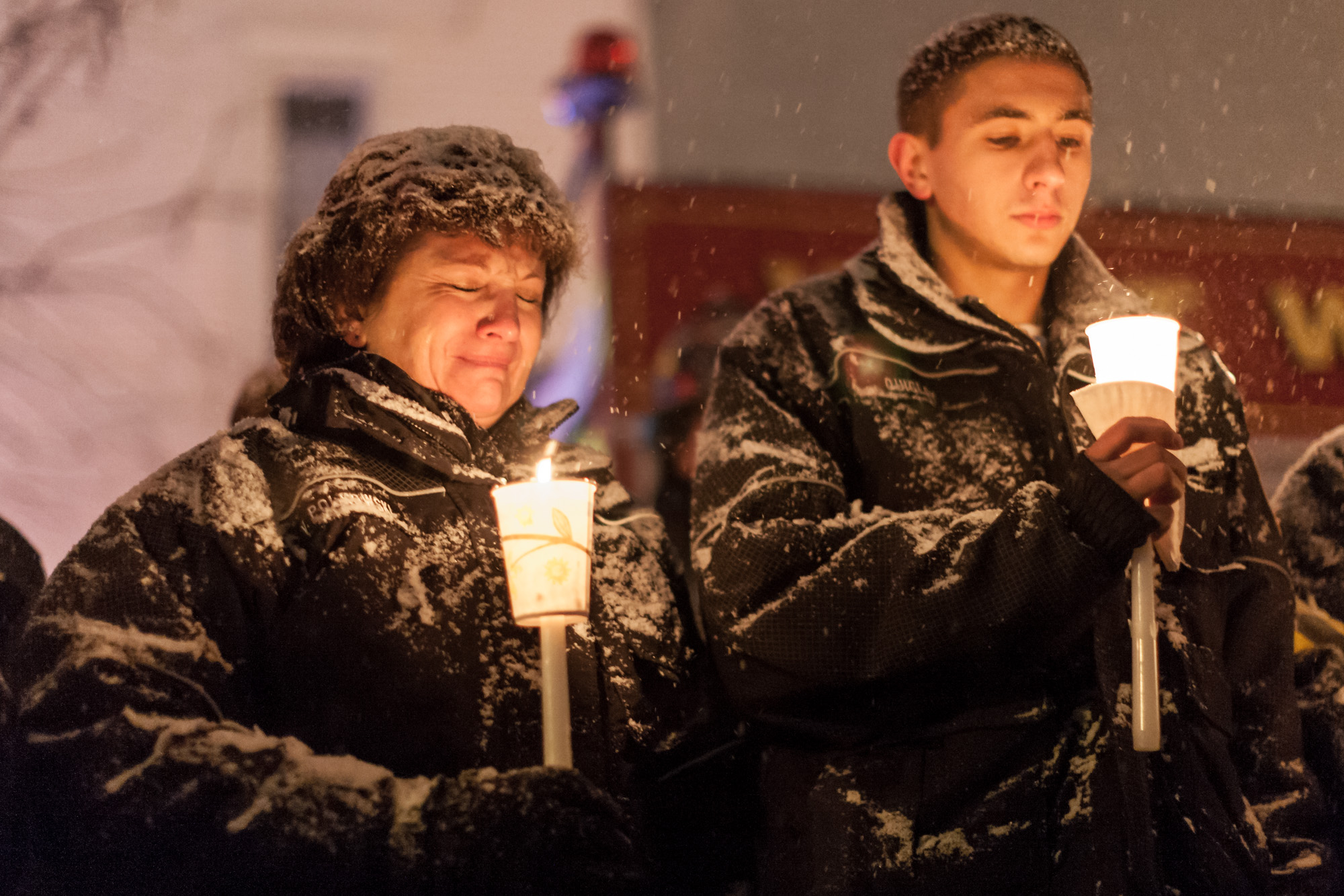 [POTW wek 4-5, Third Place] In Webster, NY, West Webster firefighter Vicki Polkowski cries with fellow firefighter, Pat Quigley, at a vigil held for two West Webster volunteer firefighters, Tomasz Kaczowka, a 911 dispatcher in his early 20s, and Michael Chiapperini, a 43-year-old lieutenant with the Webster Police Department, December 26, 2012. After arriving at a car fire which set ablaze seven homes on Lake Rd, both men were killed after being shot at on the morning of Christmas Eve by 62 year old William Spengler. The vigil was organized by the owners of Barry's Old School Irish restaurant on Main Street in Webster.