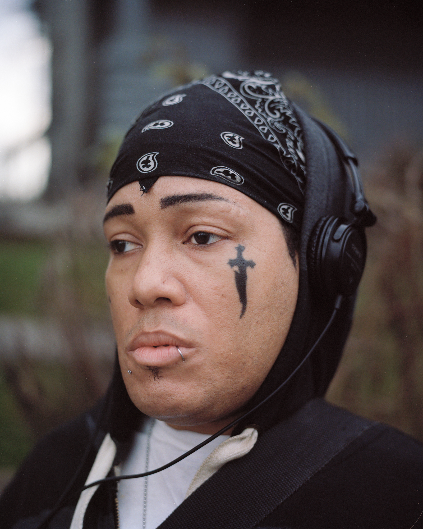 Kirk poses for a portrait on West Main Street in Rochester, NY. Kirk had his face tattooed by his father, a Native American priest, a year before he passed away. His father also tattooed the word "Priest" on his neck. Kirk moved to Rochester in 2004 from Los Angeles, CA.