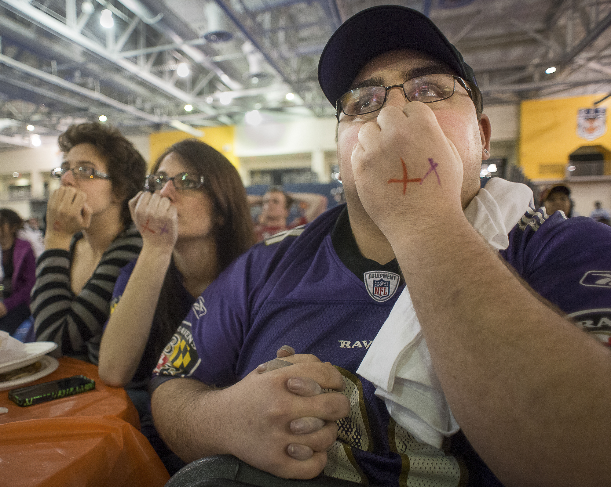 Baltimore Ravens fans Scott Frieman, second year business studies major, right; holds  the hand of his girlfriend Shaylee Fogelberg (cq), third year arts and imaging studies major, center; as they watch the game with friend Kaitlin Newhard, second year arts and imaging studies major, left; at the "Superb'OWL Party"  viewing of Super Bowl XLVII held as part of Rochester Institute of Technology's Freezefest at Gordon Field House on the university's campus in Henrietta, N.Y., on Sunday, Feb. 3, 2012. Though the Ravens never trailed in their 34-31 victory over the San Fransisco 49ers they gave their fans a scare saving the game with a goal line stand late in the fourth quarter.