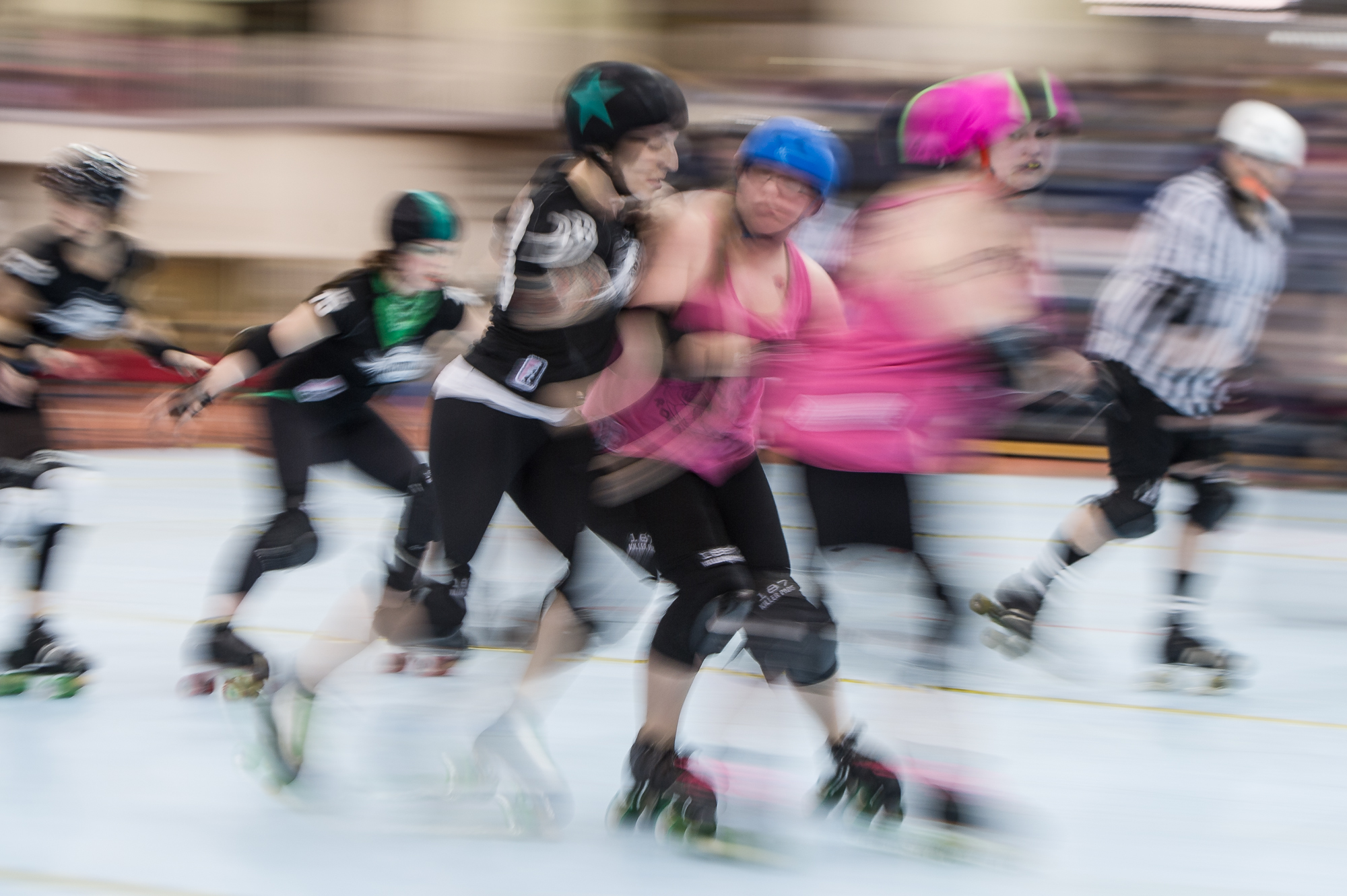 ROC Stars jammer Halestorm, wearing the helmet marked with a star, collides with Hellions of Troy blocker Lil' Wheezy, wearing a blue helmet, during a bout at the ROC City Roller Derby's Shave and a Track Cut at Rochester Institute of Technology's Gordon Field House in Henrietta, N.Y. on Saturday, March 23, 2013. The ROC Stars defeated the Hellions by an impressive margin in the second match of the night which benefited St. Baldrick's Foundation, a charity funding research of cures for children's cancer.