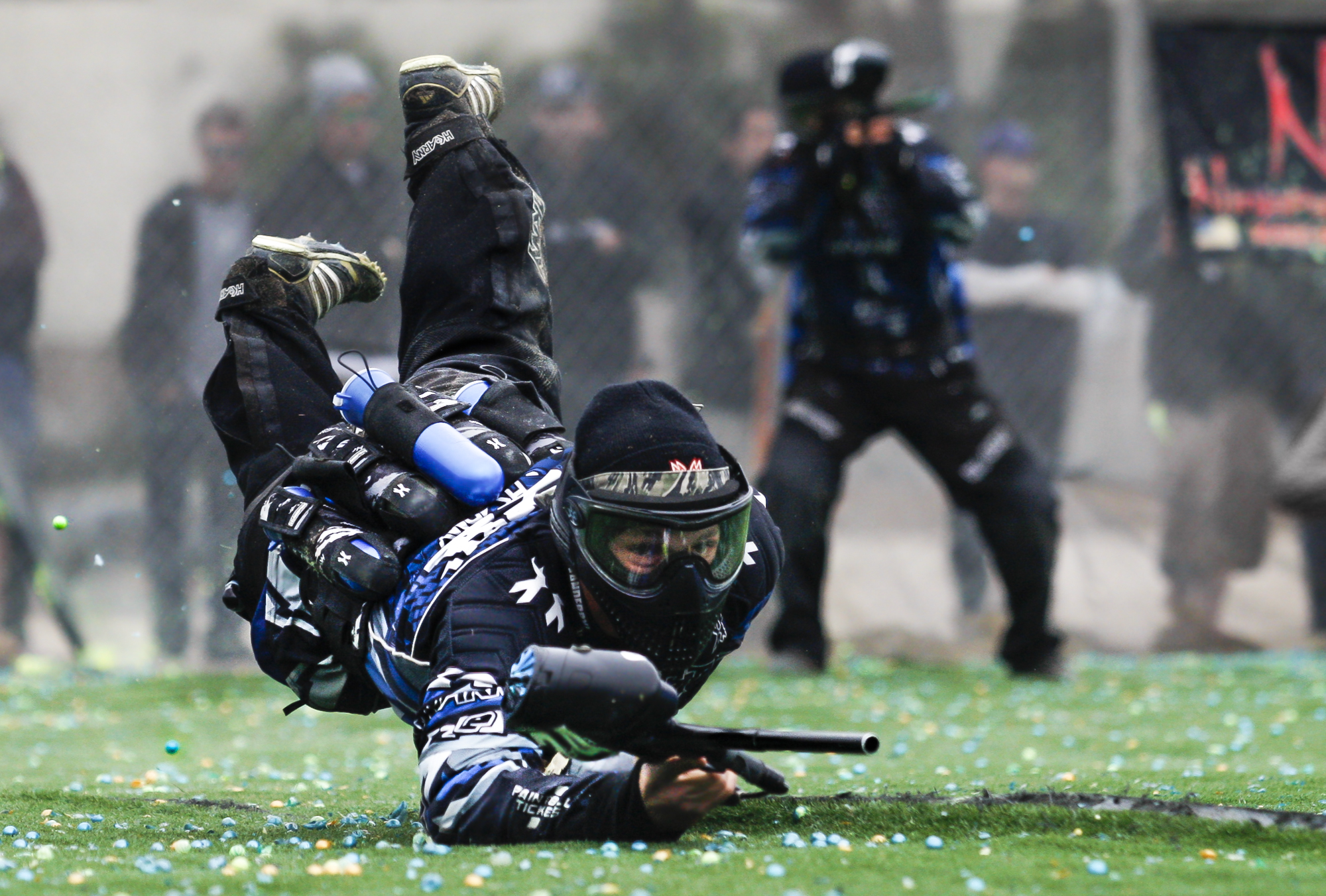 San Diego Dynasty player Dalton Vanderbyl dives for cover seconds after the start of a point against Portland Uprising during a National Professional Paintball Leauge event in Huntington Beach, California on April 14, 2013.