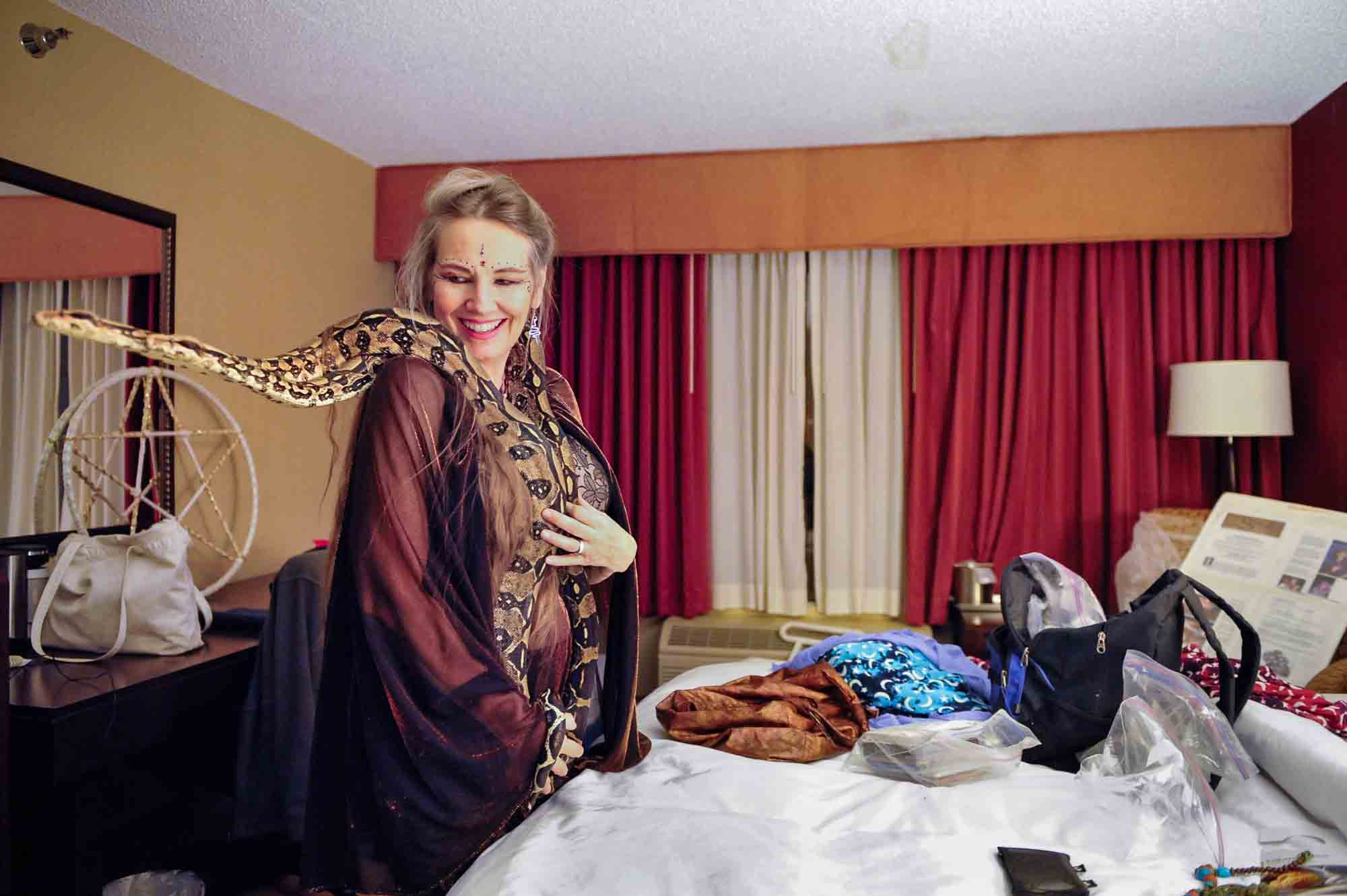 Snake priestess Serpentessa with two of her boa constrictors in her room at the Radisson Hotel after performing a belly dance during the Rochester Erotic Arts Festival April 5, 2013.