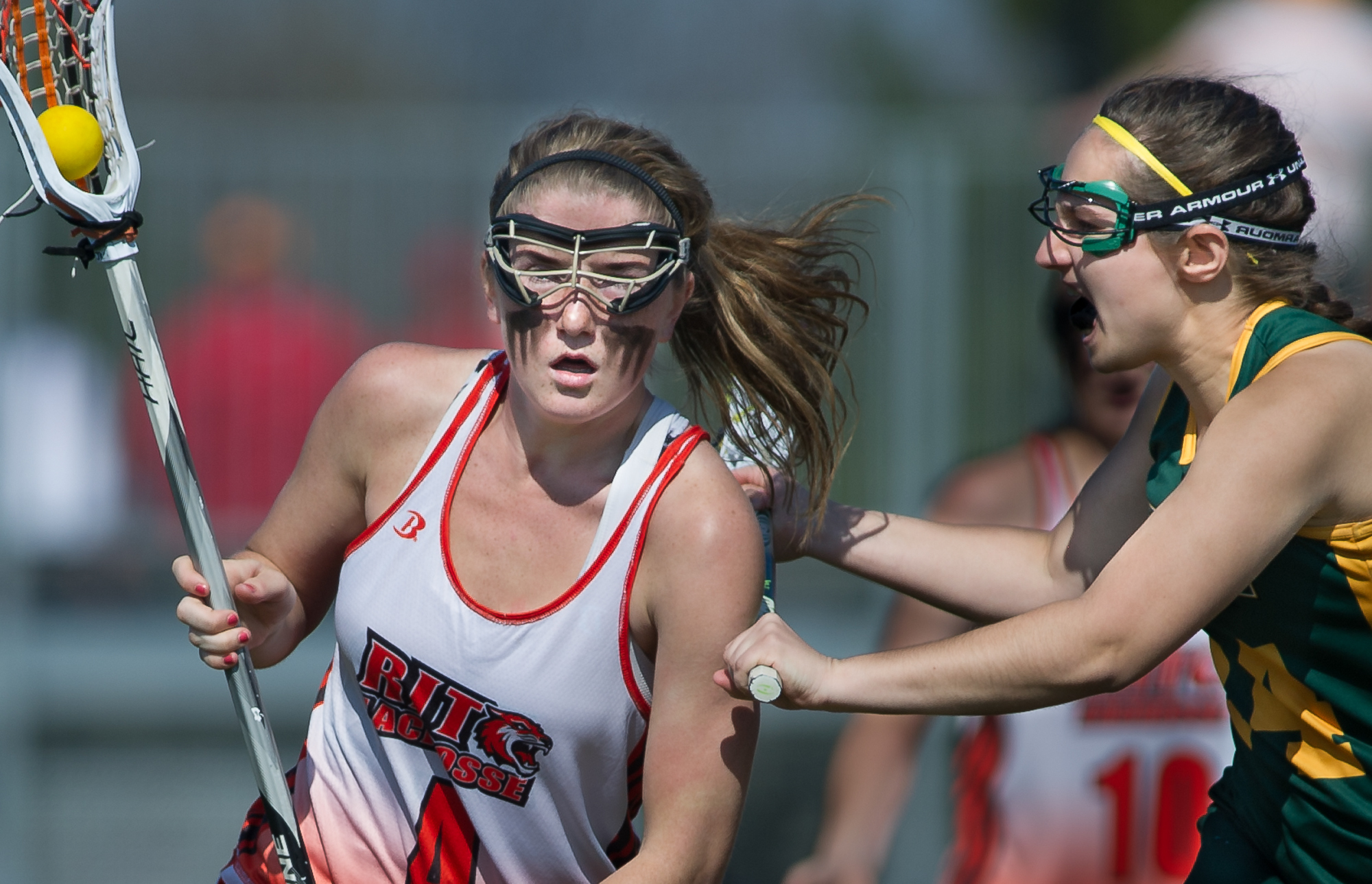 Rochester Institute of Technology's Sage Sarkis is checked by Clarkson University's Morgan McGowan during the RIT's 17-16 win over Clarkson at RIT's Tiger Stadium in Henrietta, N.Y., on Friday, April 27, 2012.