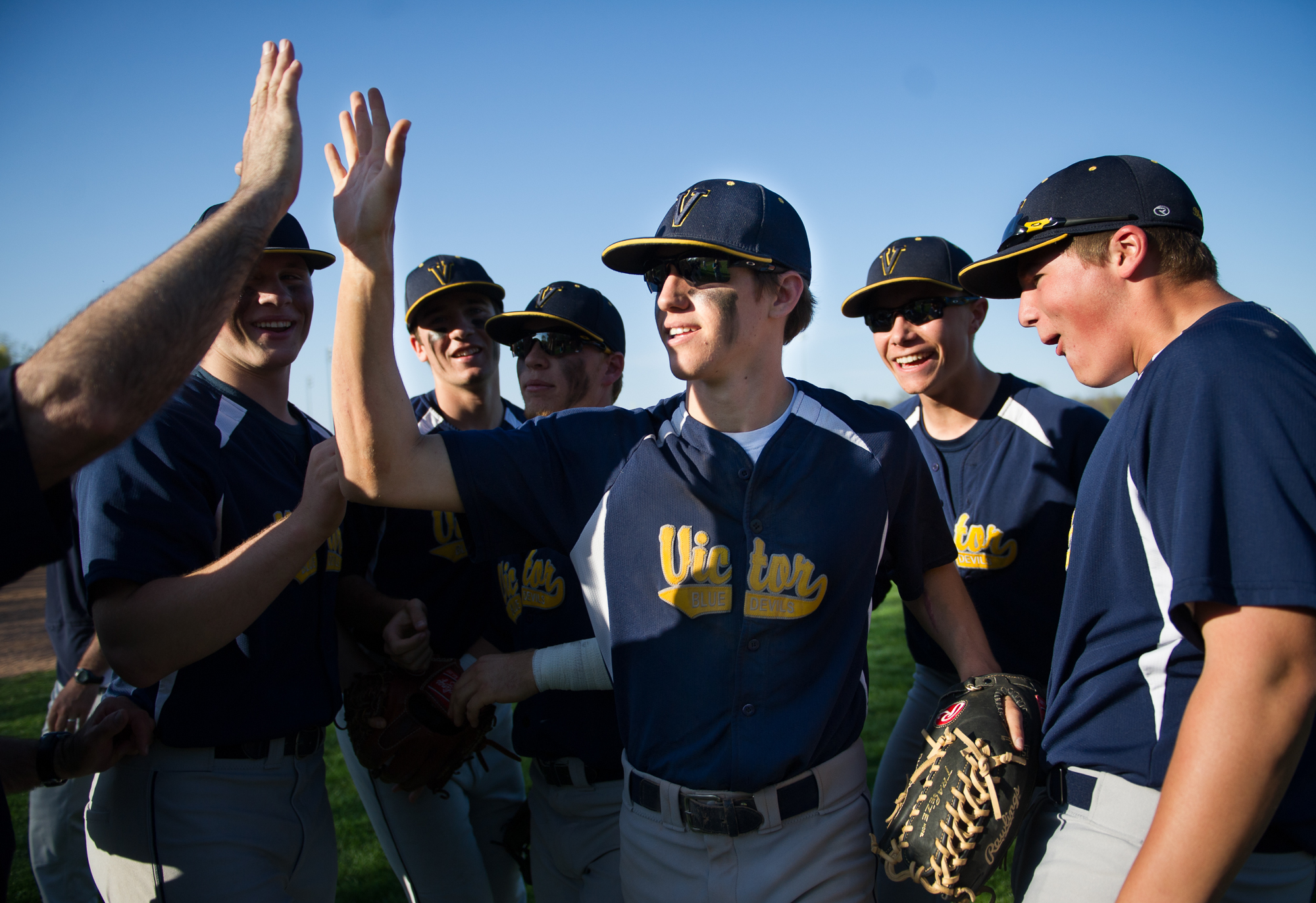 Victor outfielder Josh Busch is congratulated by teammates after his assist on the final out of a 3-2 win over Webster Schroeder in Webster, N.Y., on Wednesday May 1, 2013. Busch's throw beat the Schroeder runner to third base where Pete Carrier was able to tag the runner out in a close play ending Schroeder's comeback in the final inning of the game.