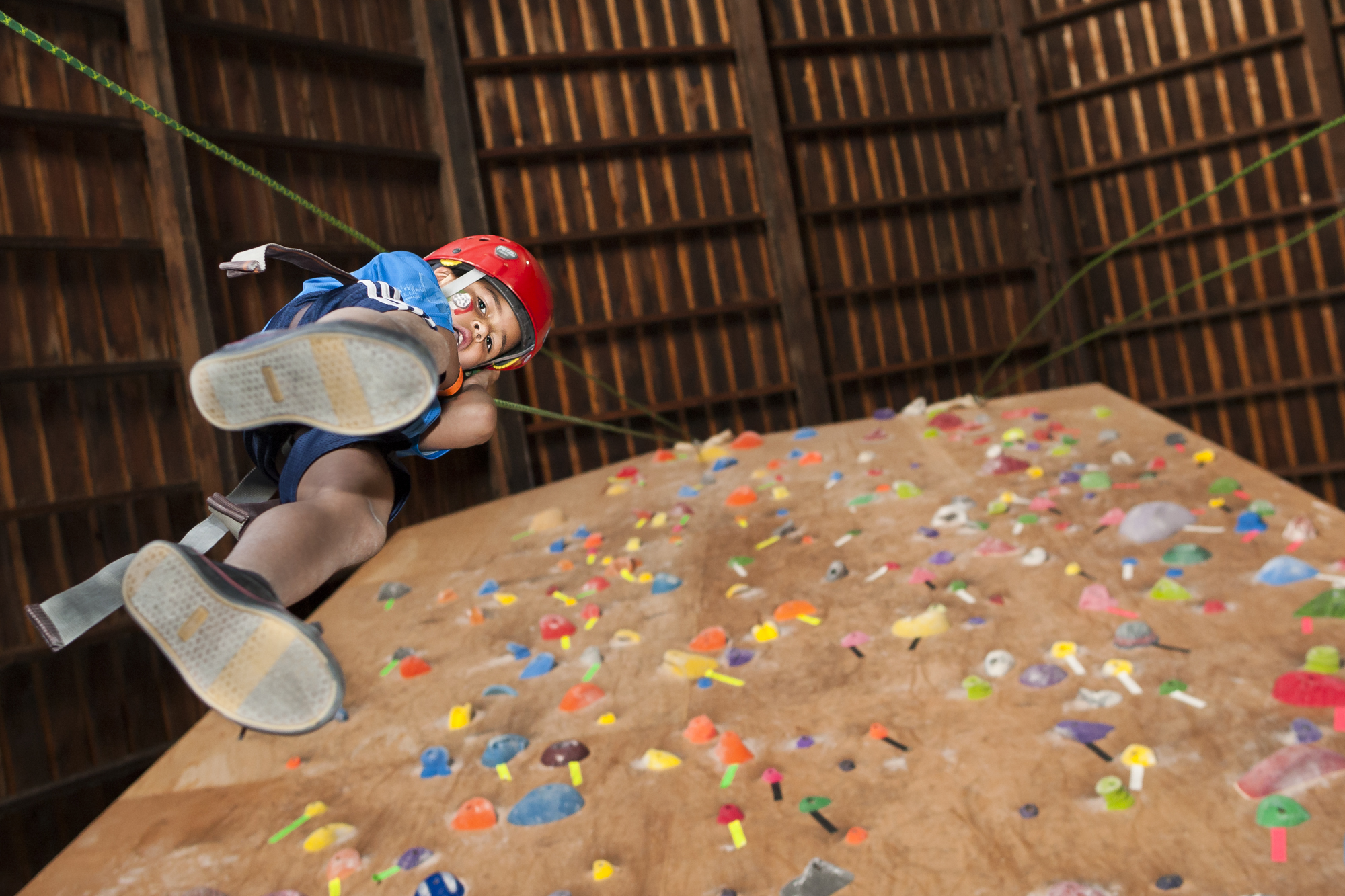 Jahlier Miller descends down a rock climbing wall during the Imagine R.I.T. festival in Henrietta, NY, on Saturday, May 4, 2013.