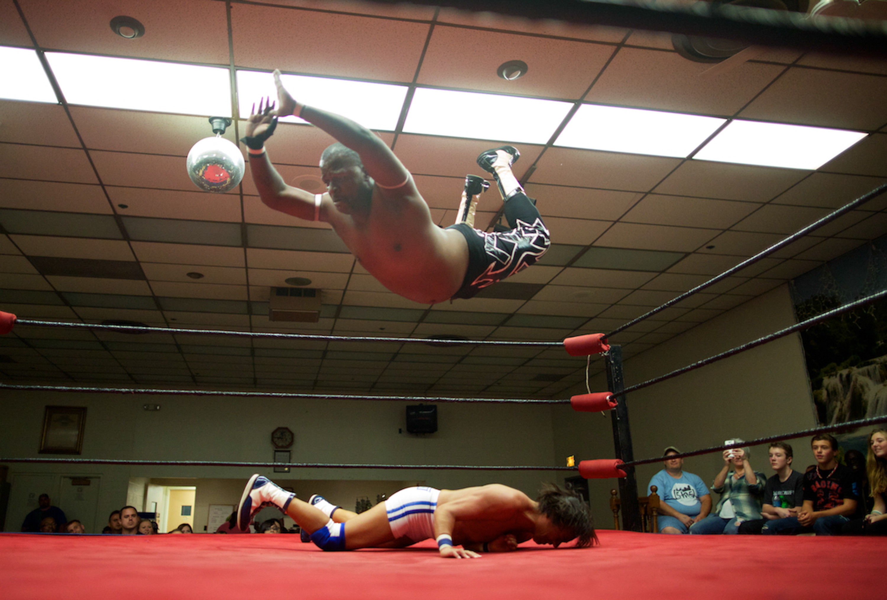 9/21/13 - At the Eagles Club in Rochester, NY Professional Wrestler Gabrael Saint leaps from the ropes onto his Japanese opponent Shoichi Funaki. Photo by Joe Philipson 