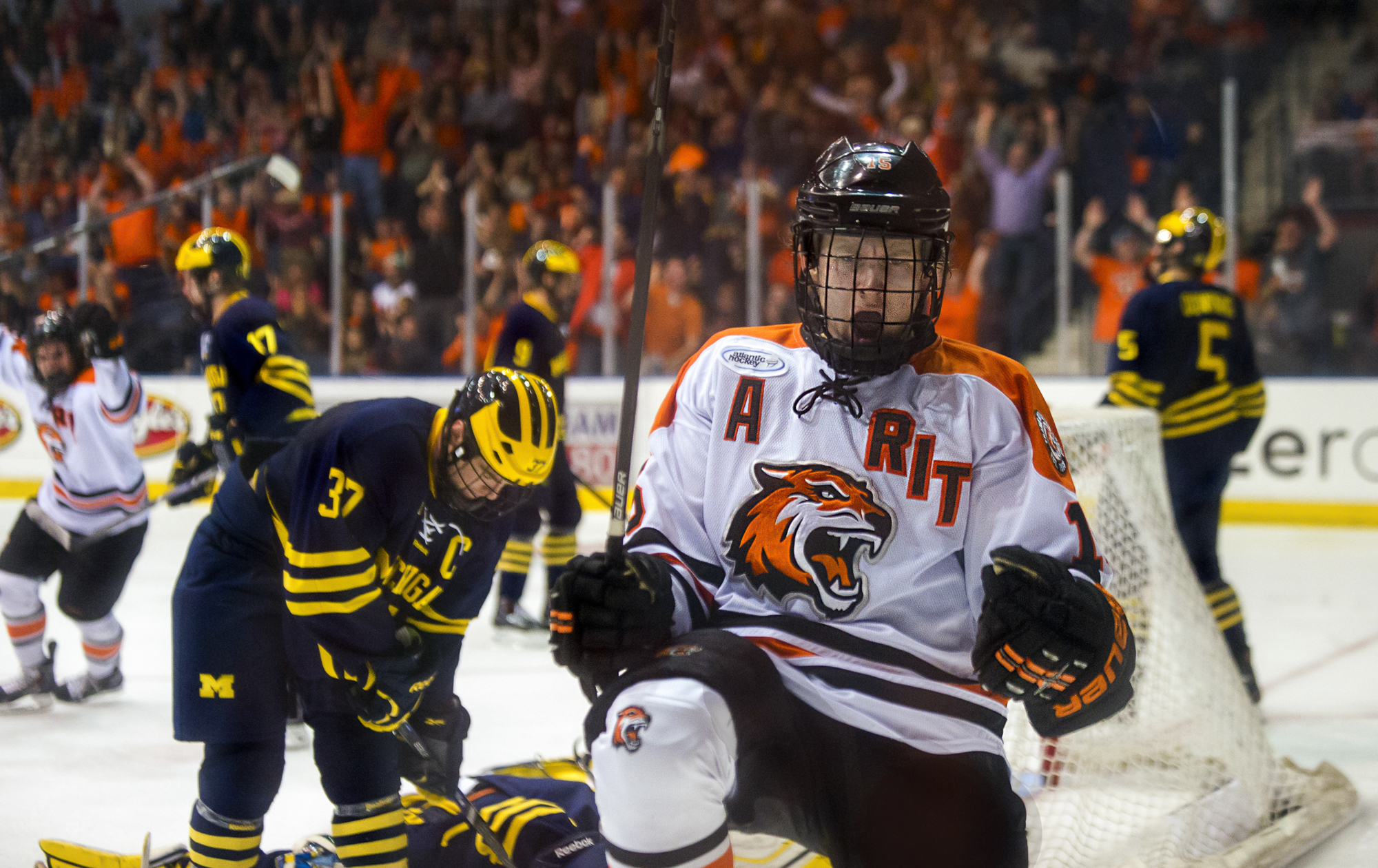 Rochester Institute of Technology senior co-captain forward Ben Lynch celebrates a goal against University of Michigan-#5 during the annual Brick City Homecoming ice hockey game on October 12, 2013 at the Blue Cross Arena in Rochester, New York.  Lynch's goal would give the Tiger's their second goal of the night, contributing to a 4-4 tie by the end of the second period, but Michigan would score another three goals in the third period to win. Photo by Tom Brenner