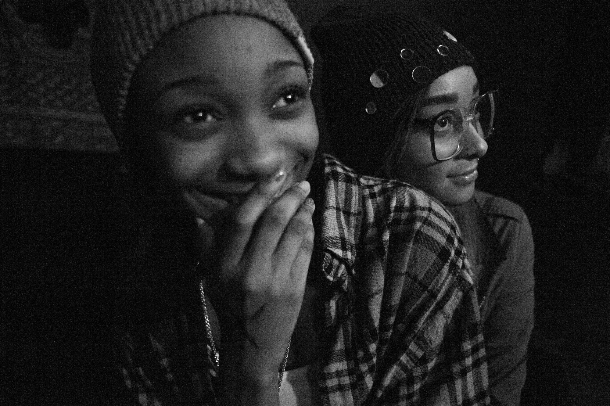 Two girls watch a hip-hop show at the Bug Jar while "Ishmael Raps" performs. This was the first hip-hop show in close to a year following a hiatus caused by a murder occurring at the venue. Photo by Daniel Witkowski