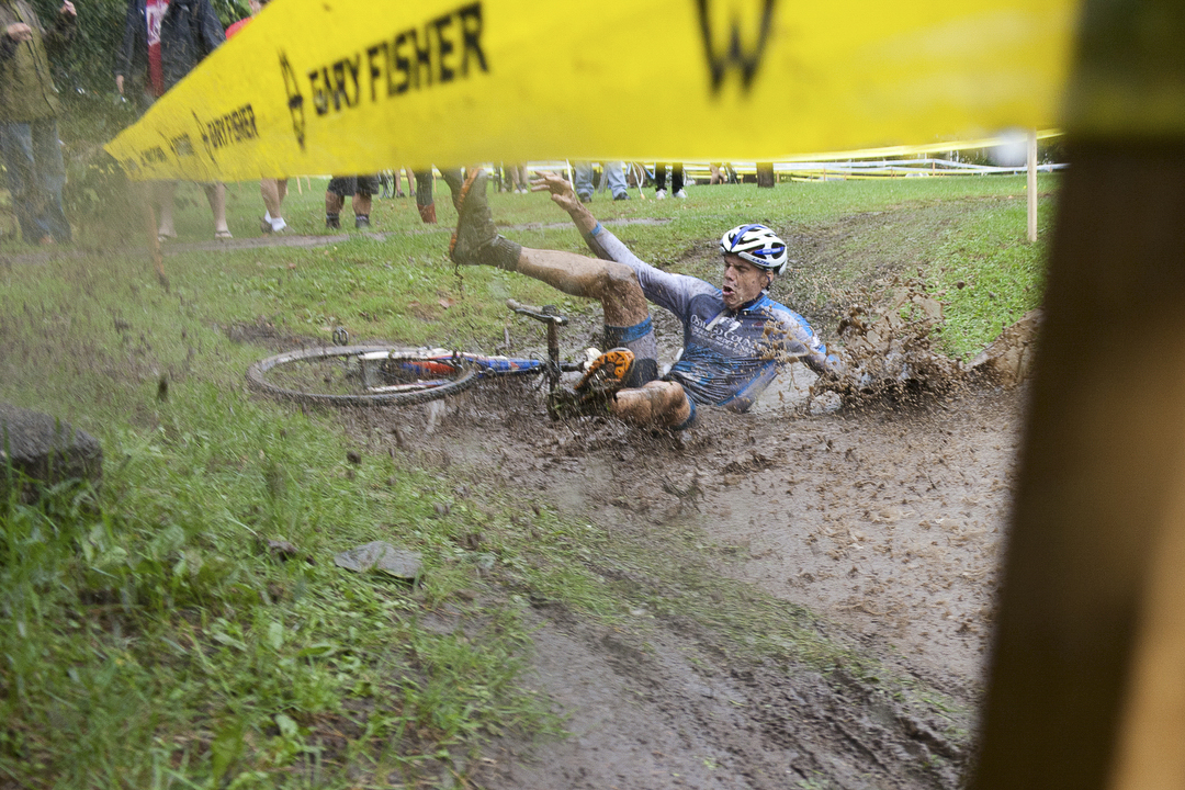 Gerald Visconti of the OCFCU Cycling Project takes a spill into a mud puddle during the Masters Men 40+ at the Cobb's Hill cyclocross race at Cobb's Hill Park on Sunday, Oct. 6, 2013. Cyclocross consists of many laps in which cyclists ride over pavement, grass, steep hills, and obstacles in which they quickly dismount and navigate the obstruction. "They changed the course last minute, I went right into the water. Whoosh!" said Visconti. Photo by Rugile Kaladyte 