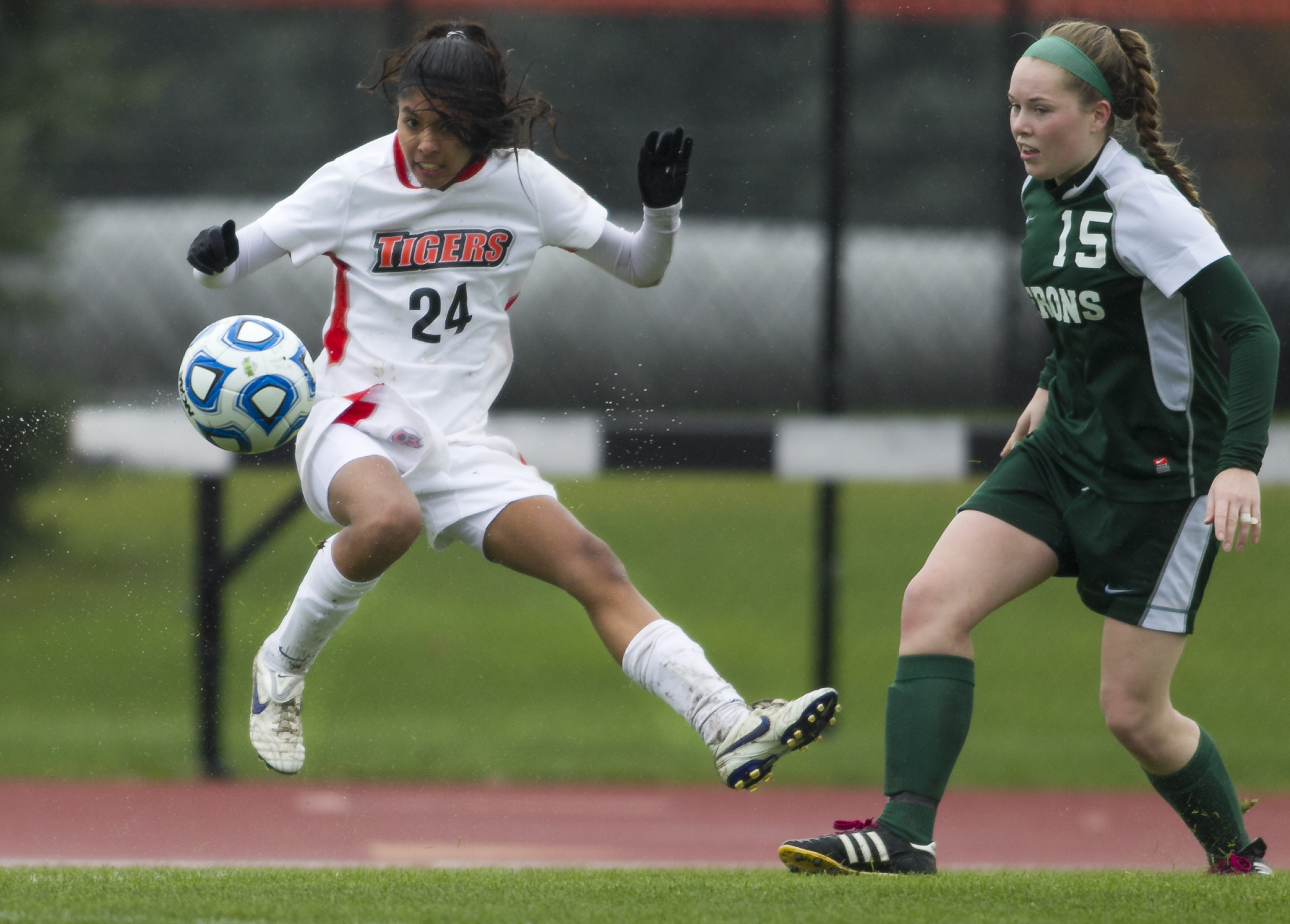 Anka Parzych of RIT #24, left, serves the ball into the William Smith goal box during the women's soccer game at Rochester Institute of Technology's Tiger Stadium in Henrietta, N.Y., on Saturday, Nov. 2, 2013. (Photo by Josh Barber/RIT SportsZone)