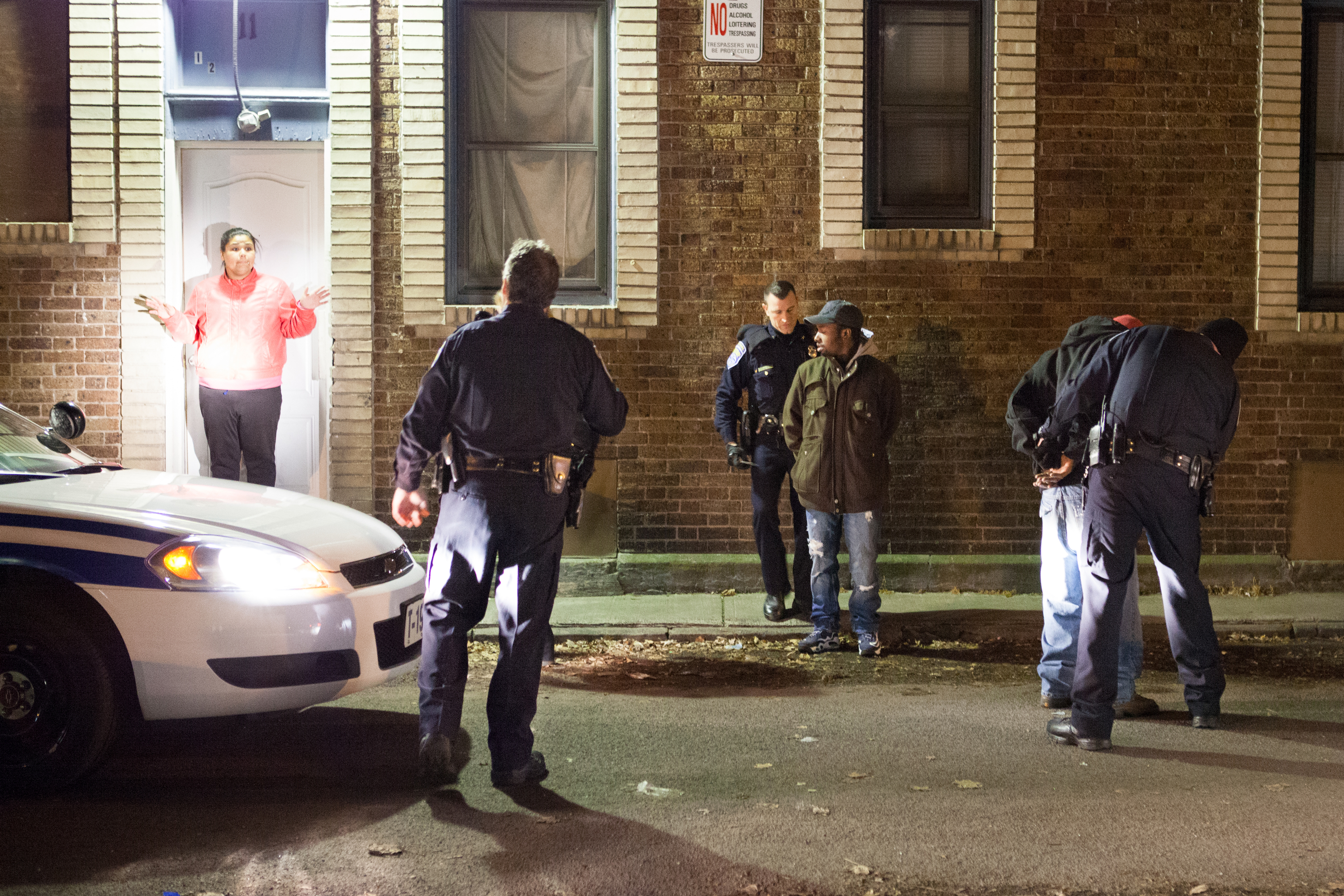 A young woman outside her home reacts to Lieutenant Eric Paul and his officers arresting two men suspected of carrying a weapon in Rochester, N.Y., on Nov. 19, 2013. The two individuals were released immediately after it was determined that they were not who the police were looking for. Photo by Rugile Kaladyte