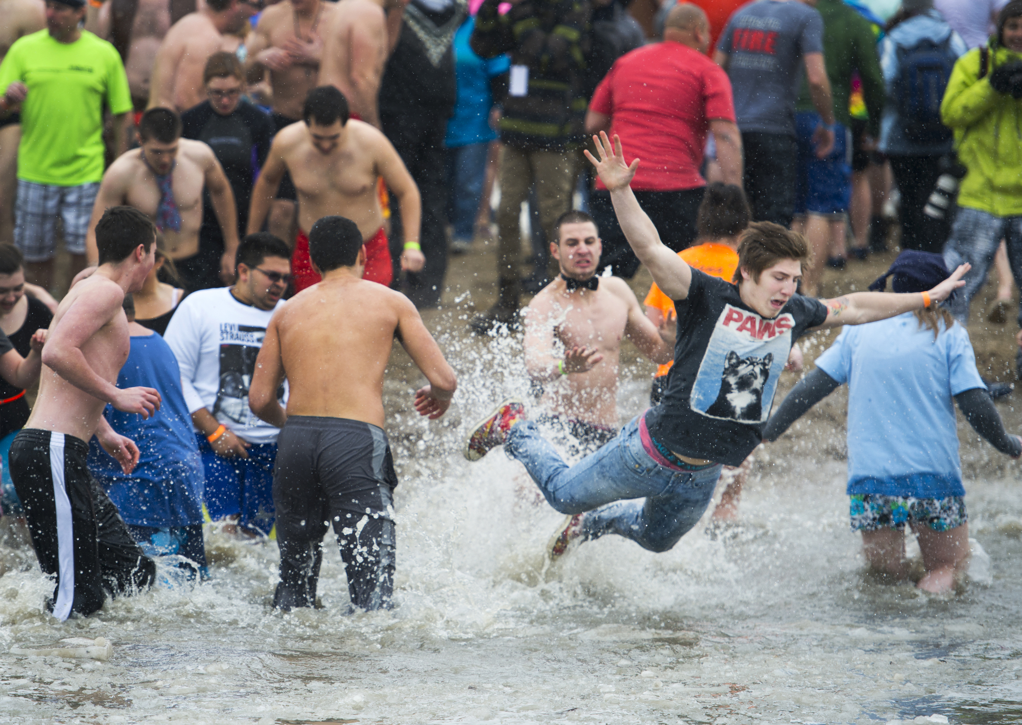 A young plunger belly flops into icy water during the Rochester Polar Bear Plunge at Charlotte Beach in Rochester, New York on February 9, 2014. Photo by Tom Brenner