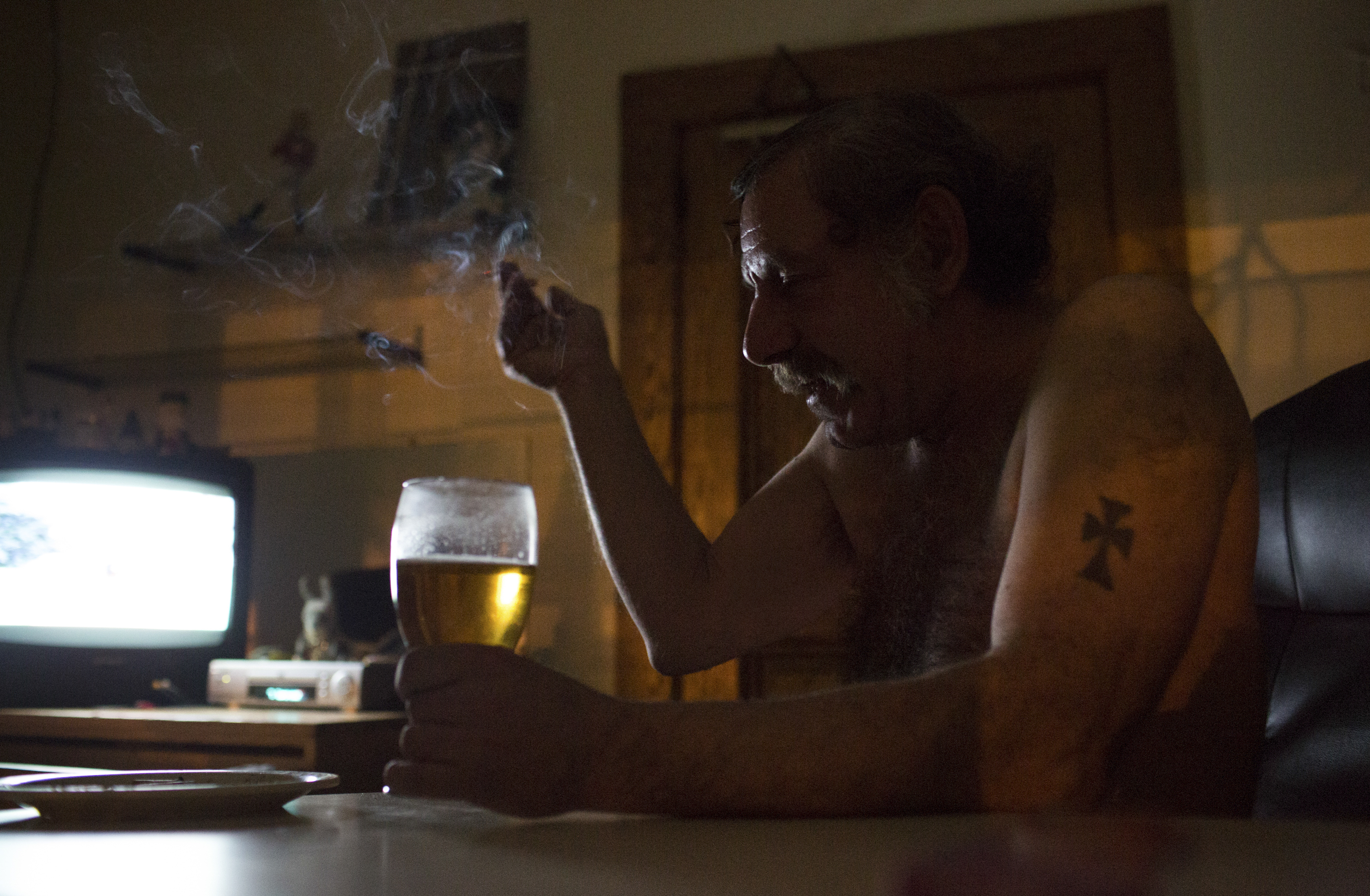 Bradley Loce, 56, takes a quiet moment in his Dorothy Day House apartment in Rochester, NY on Feb. 23, 2014. "My son hasn't talked to me in fifteen years. He's ashamed of me because I'm a drunk. Can't blame him. I'm not a criminal though."  Bradley has suffered from alcoholism his entire life, has struggled with chronic homelessness and mental illness diagnosis that he rejects, refusing medication. The Dorothy Day House has been in place since late 2012, providing a housing first solution for people that are on the streets. Photo by Zack DeClerk