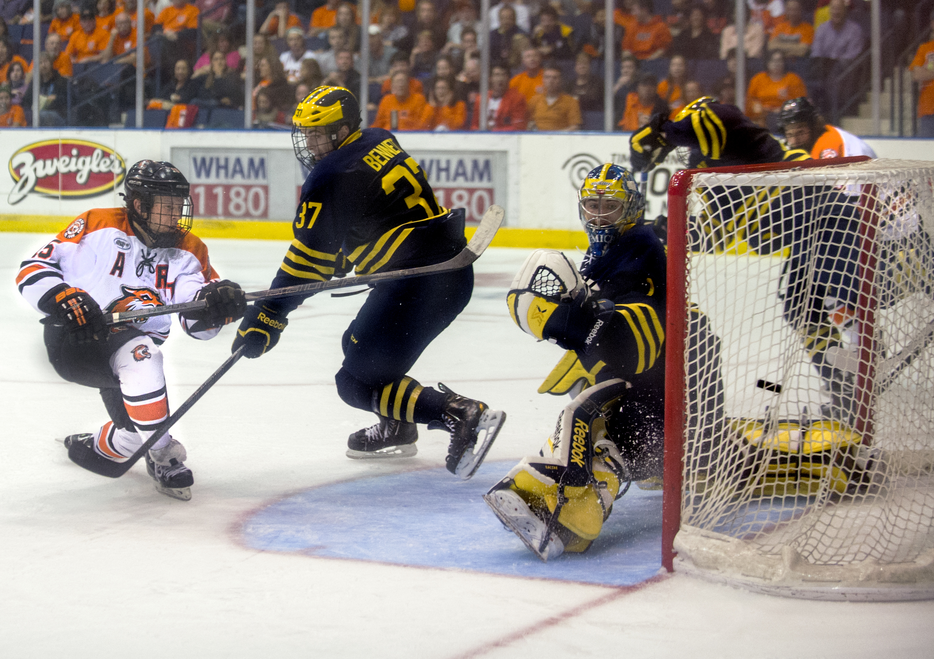 Rochester Institute of Technology co-captain Ben Lynch-#15 scores a goal against University of Michigan during the Brick City Homecoming game on October 12, 2014 at the Blue Cross Arena in Rochester, New York. Photo by Tom Brenner 