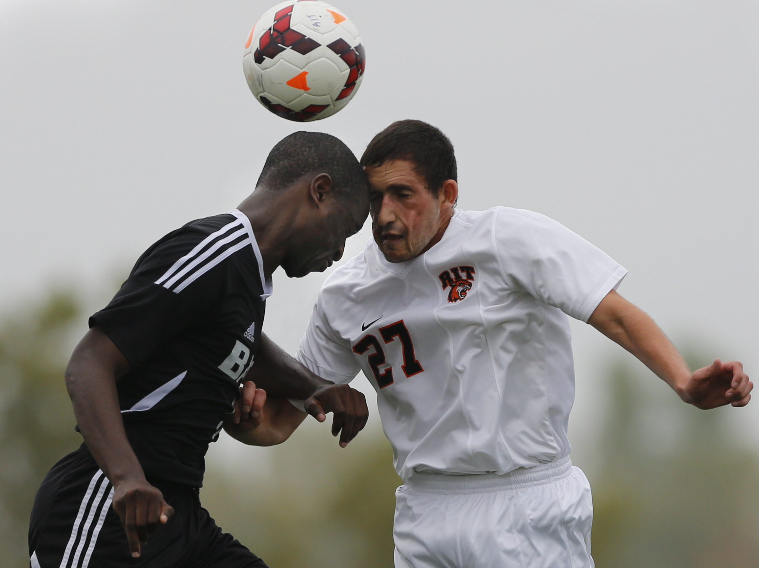 Kurt Spiegel a junior at Rochester Institute of Technology bangs heads with Gabriel Kilongo a junior at Bard College during a MenÍs soccer game between RIT and Bard College in Henrietta, New York on October 4, 2013, which ended with a final score of 4-0 RIT. Photo by Flannery Allison 