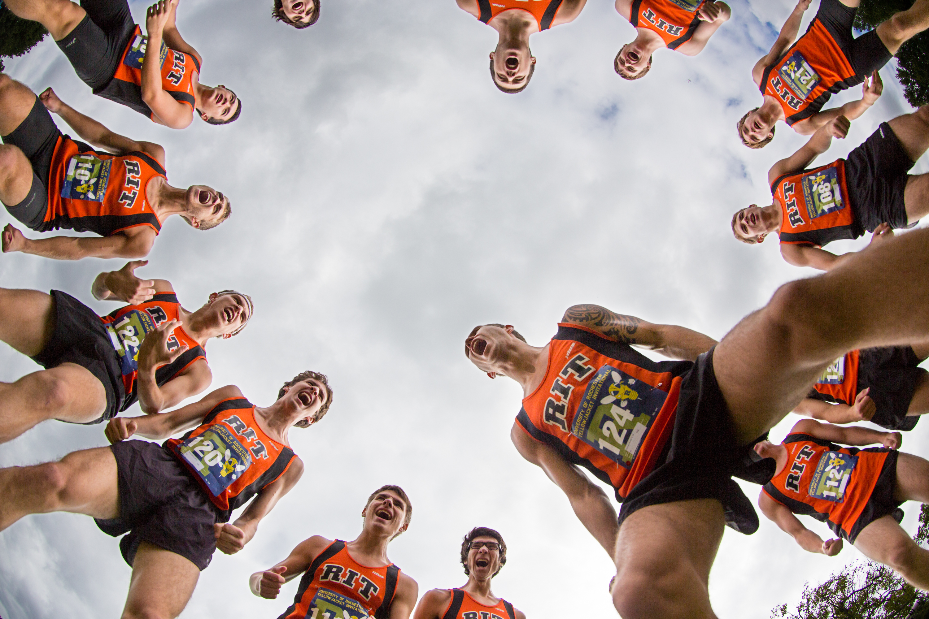 The RIT men's cross country team cheers before the University of Rochester Invitational cross country meet at Genesee Valley Park in Rochester, N.Y., on Saturday, Sept. 14, 2013. Photo by Josh Barber