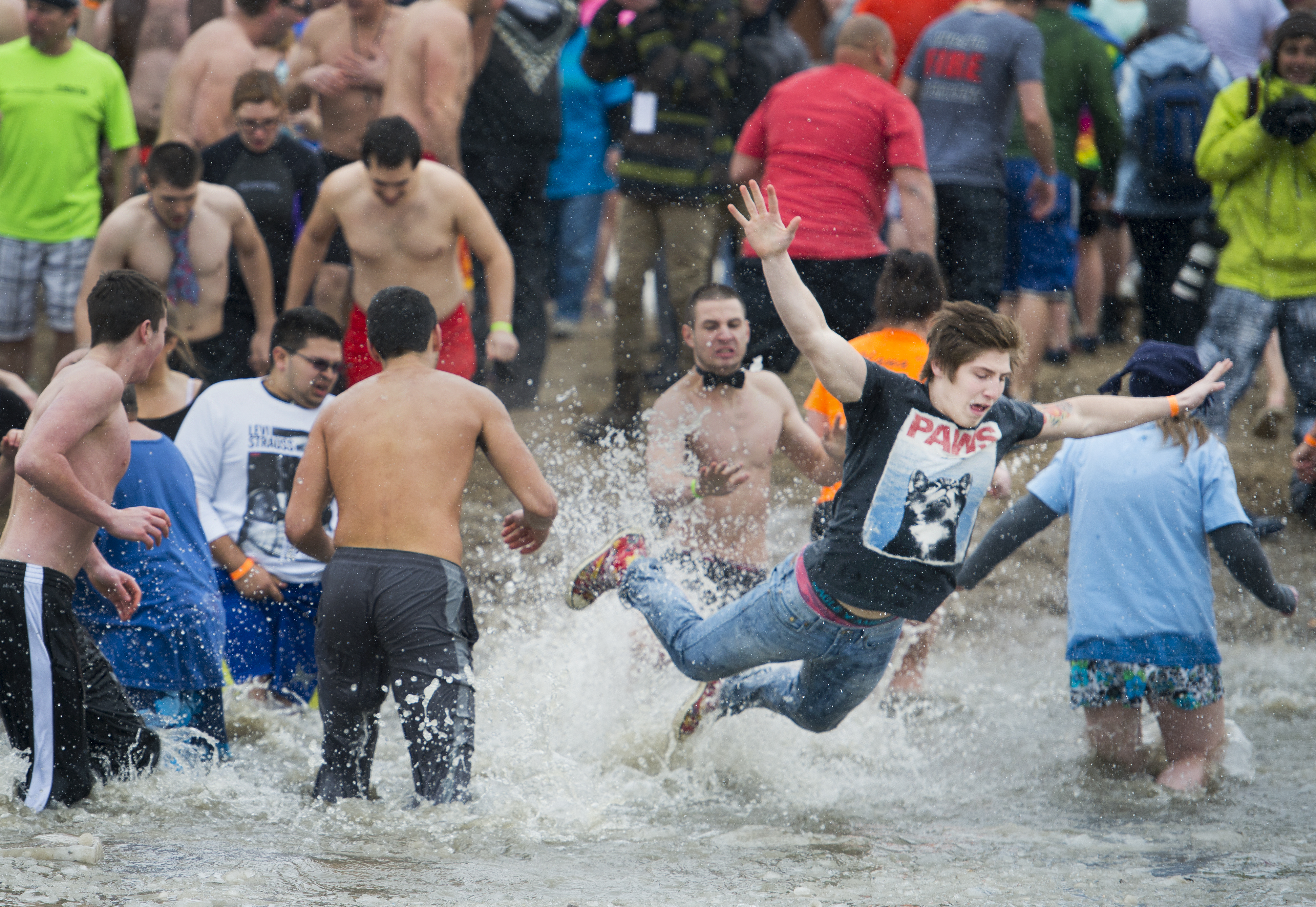 A young plunger belly flops into icy water during the Rochester Polar Bear Plunge at Charlotte Beach in Rochester, New York on February 9, 2014. Photo by Tom Brenner 