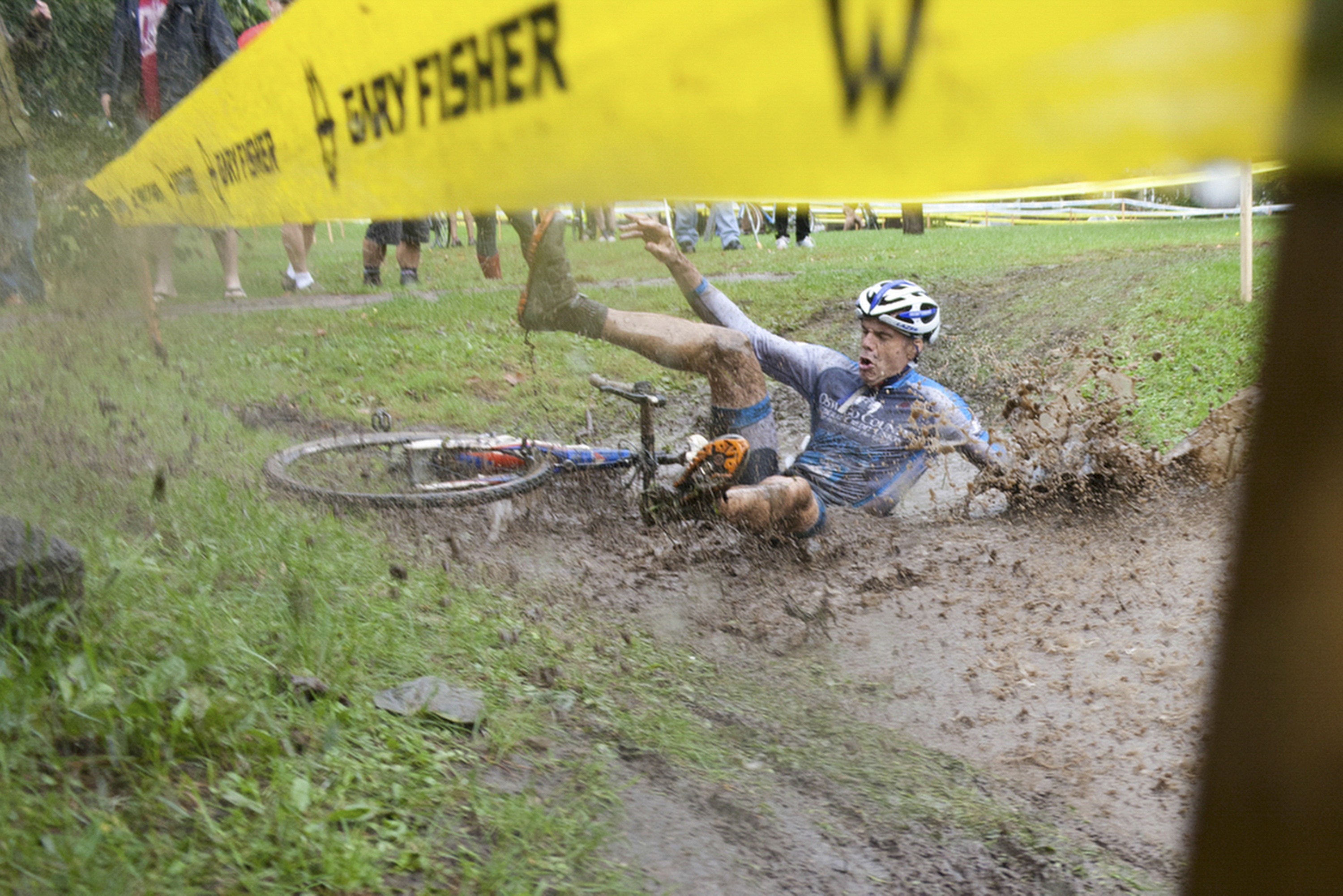 Gerald Visconti of the OCFCU Cycling Project takes a spill into a mud puddle during the Masters Men 40+ at the Cobb's Hill cyclocross race at Cobb's Hill Park on Sunday, Oct. 6, 2013. Cyclocross consists of many laps in which cyclists ride over pavement, grass, steep hills, and obstacles in which they quickly dismount and navigate the obstruction. "They changed the course last minute, I went right into the water. Whoosh!" said Visconti. Photo by Rugile Kaladyte