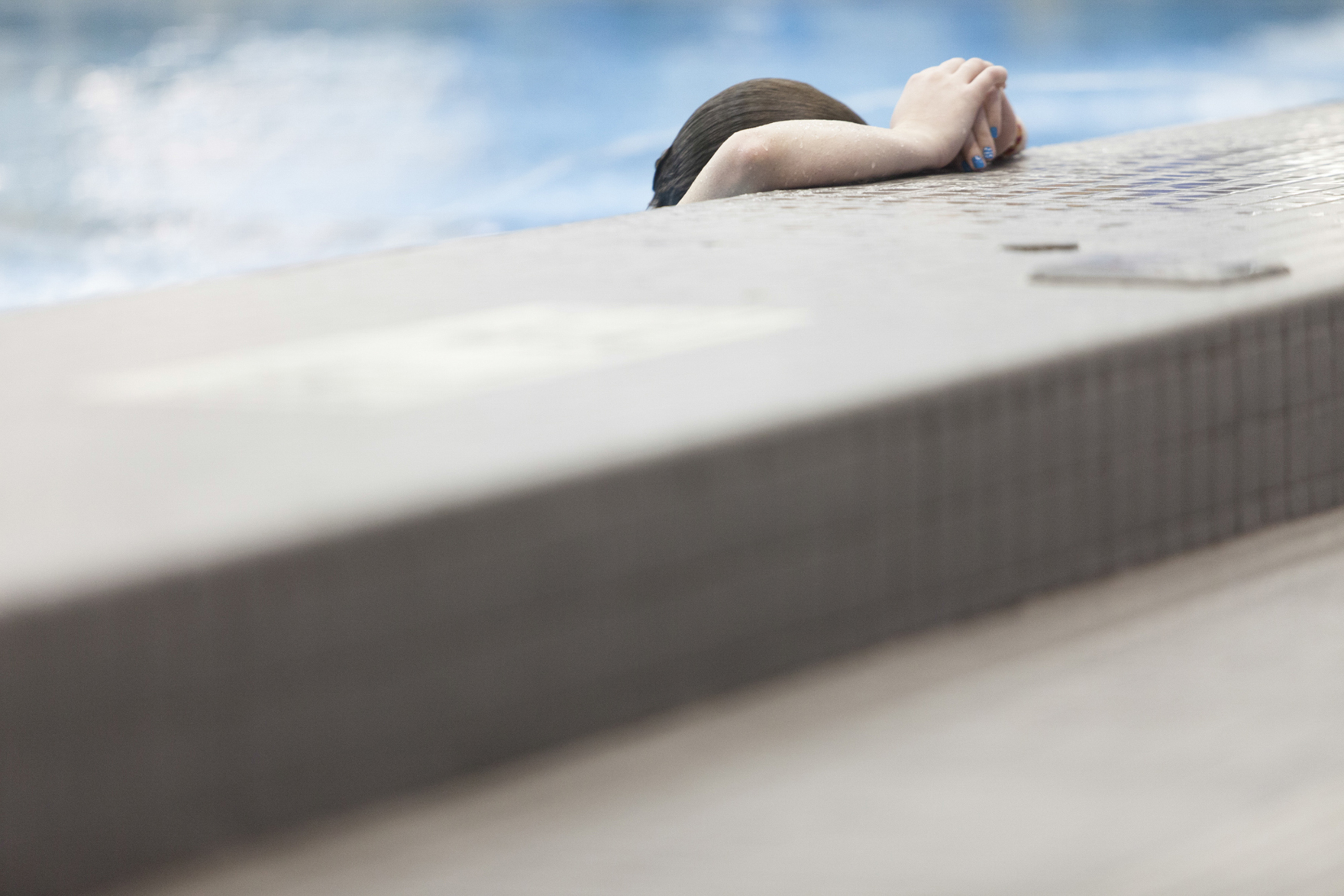 Heather Colby of the Fredonia State Blue Devils rests by the side of the pool after a dive in competition during the 2014 NCAA Division III Diving Regional for Region 4 at Judson Pool on Friday, Feb. 28, 2014 in Henrietta, N.Y. Colby finished 10th in the 1-meter competition. Photo by Rugile Kaladyte