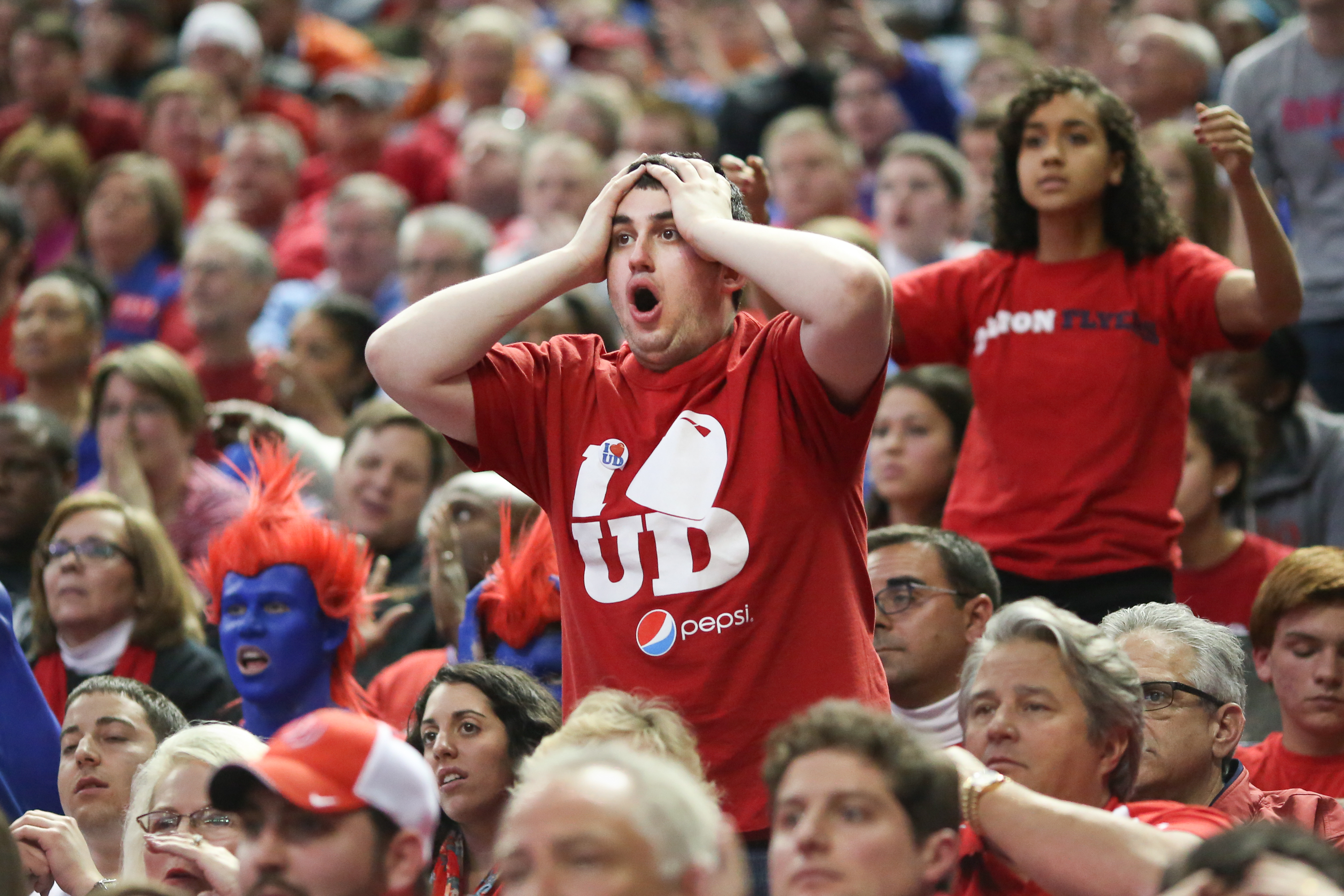  A fan of the Dayton Flyers reacts to a play during the third round of the 2014 NCAA Men's Basketball Championships against the Syracuse Orange at the First Niagara Center on Saturday, March 22, 2014 in Buffalo, N.Y. The lead changed four times in the last 10 minutes of regulation before the Flyers upset the Orange 55-53. Photo By Josh Barber