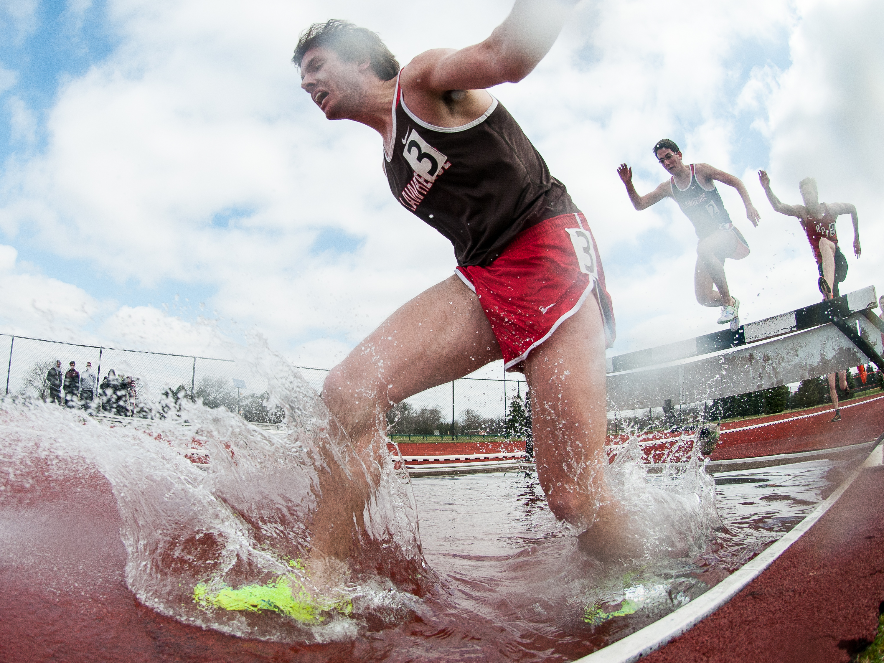Aaron Tompkins of the Saint Lawrence Saints competes in the men's 3,000-meter steeplechase during the 2014 Liberty League Track and Field Championship at Tiger Stadium on Saturday, April 19, 2014 in Henrietta, N.Y. (Josh Barber/RIT SportsZone)
