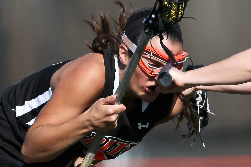 Ashleigh Caruso gets a hit to face during a game against the RPI Engineers at the RIT Turf Field on Friday, April 11, 2014 in Henrietta, N.Y. (Josh Barber/RIT Sports Information)