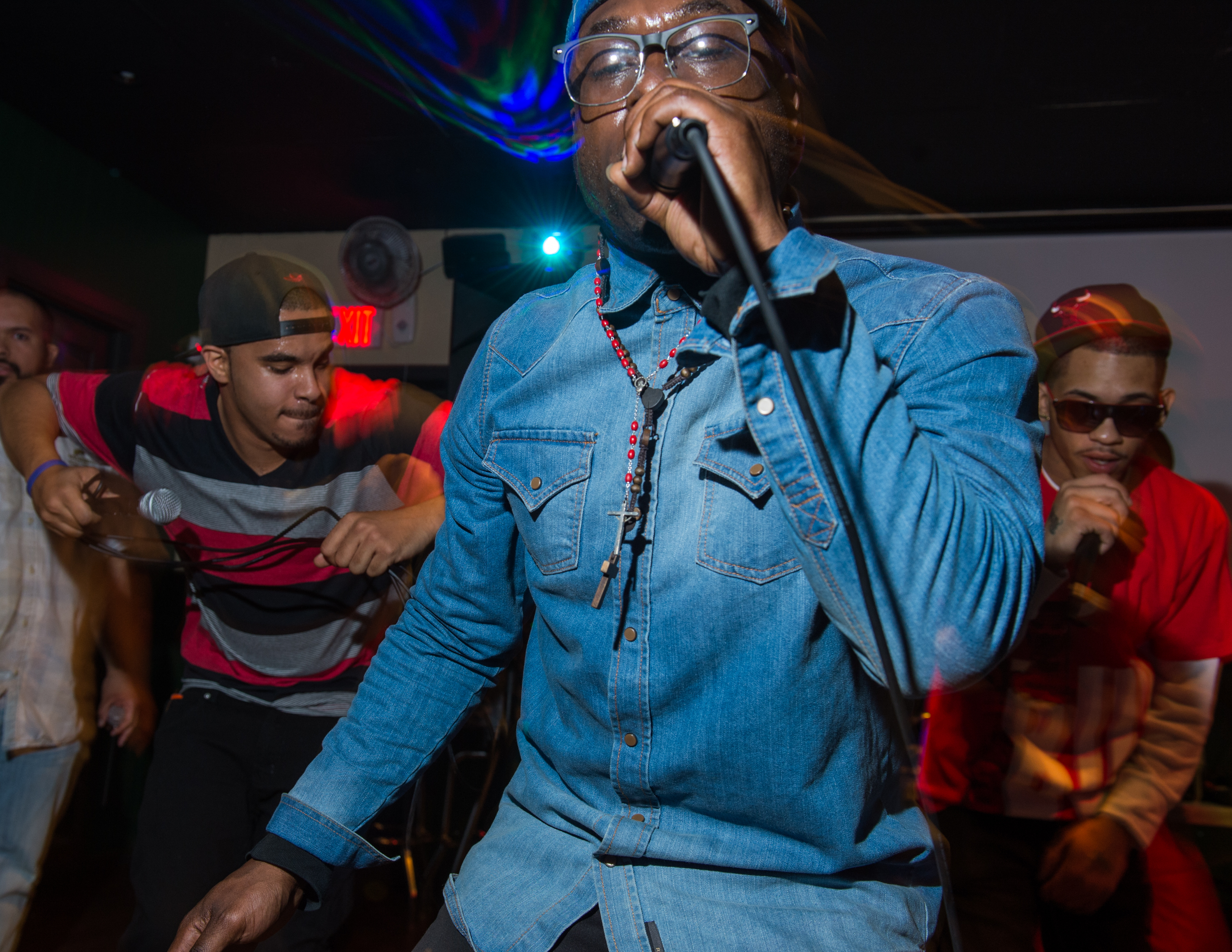 JBain DaStar (Center), of Rochester, NY, performs with group members Ricardo Murray (Left), of Rochester, NY, and Marcus Montreal (Right), of Rochester, NY, at the Thirsty Frog, in Irondequoit, NY, on April 28, 2014.  They are members of New Tren Gang, an aspiring hip-hop group founded in Rochester, NY, and this was their second live performance. Photo by David Falconieri