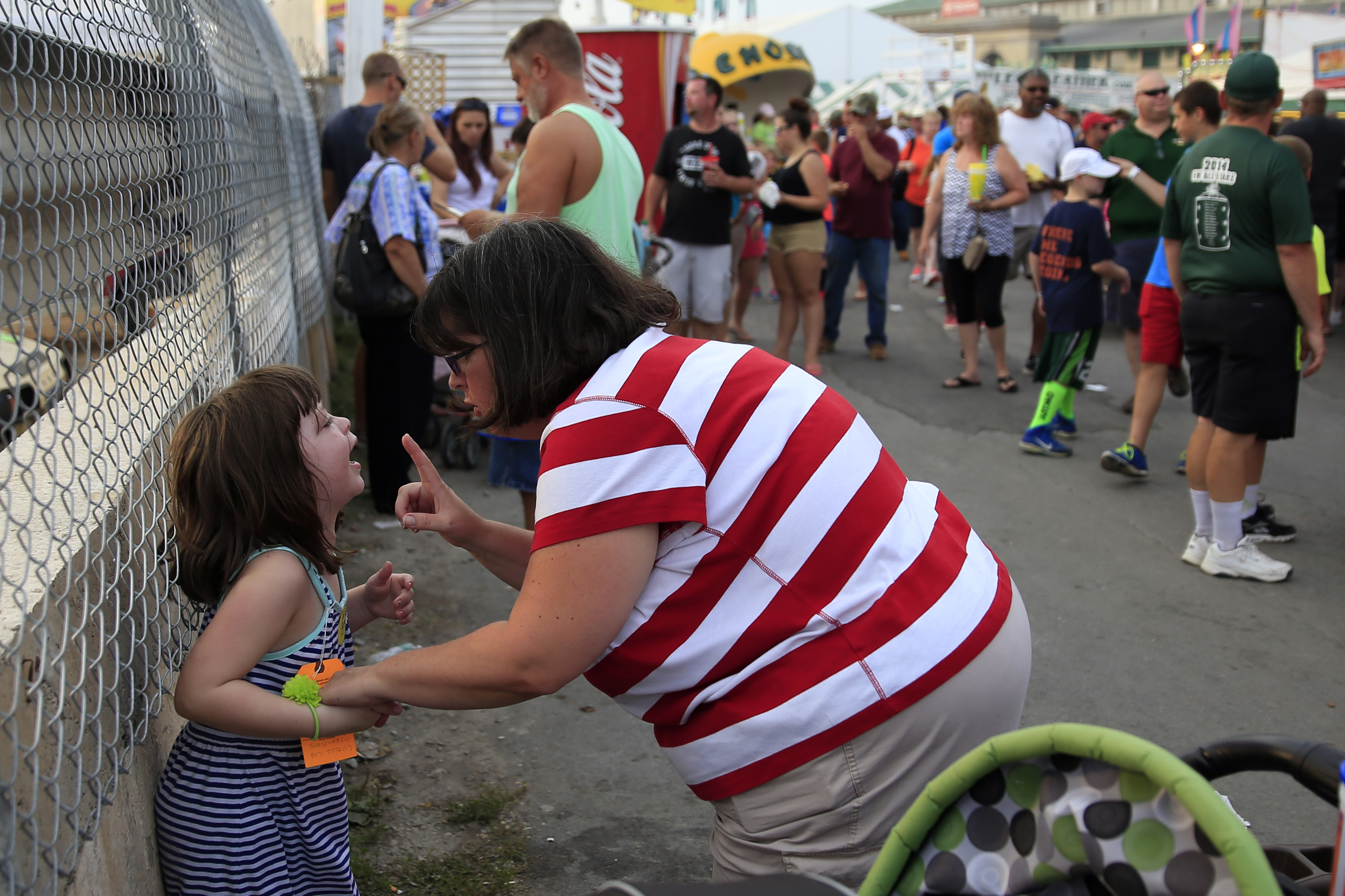 Kelly Melzer, left, is yelled at by her mother, Katy, right, after Kelly had a screaming tantrum on the fairgrounds, on Saturday, August 30, 2014 at The Great New York State Fair in Solvay, N.Y.