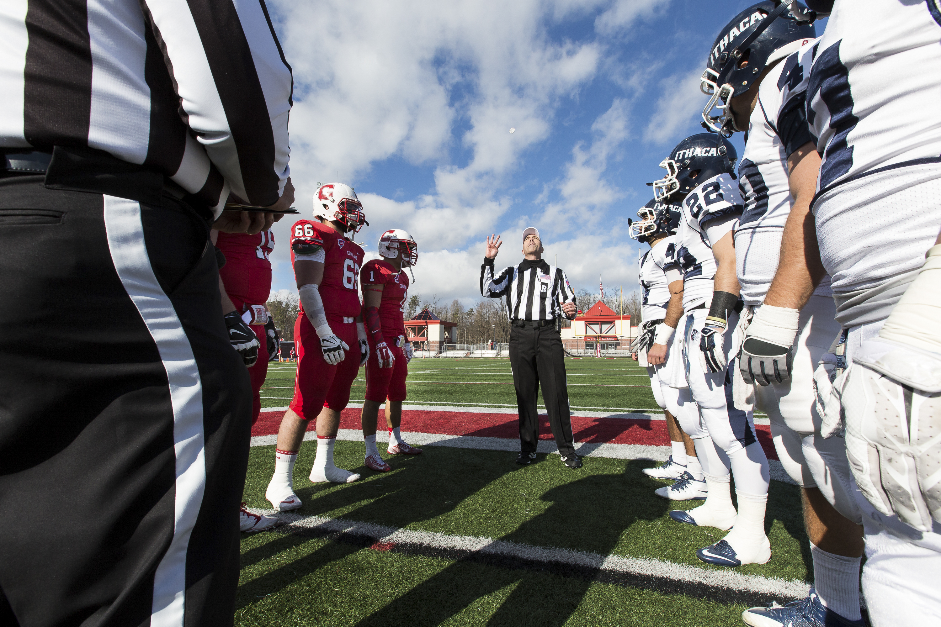 Captains of Ithaca and Cortland football teams  watch the coin toss before the football game on November 15, 2014.