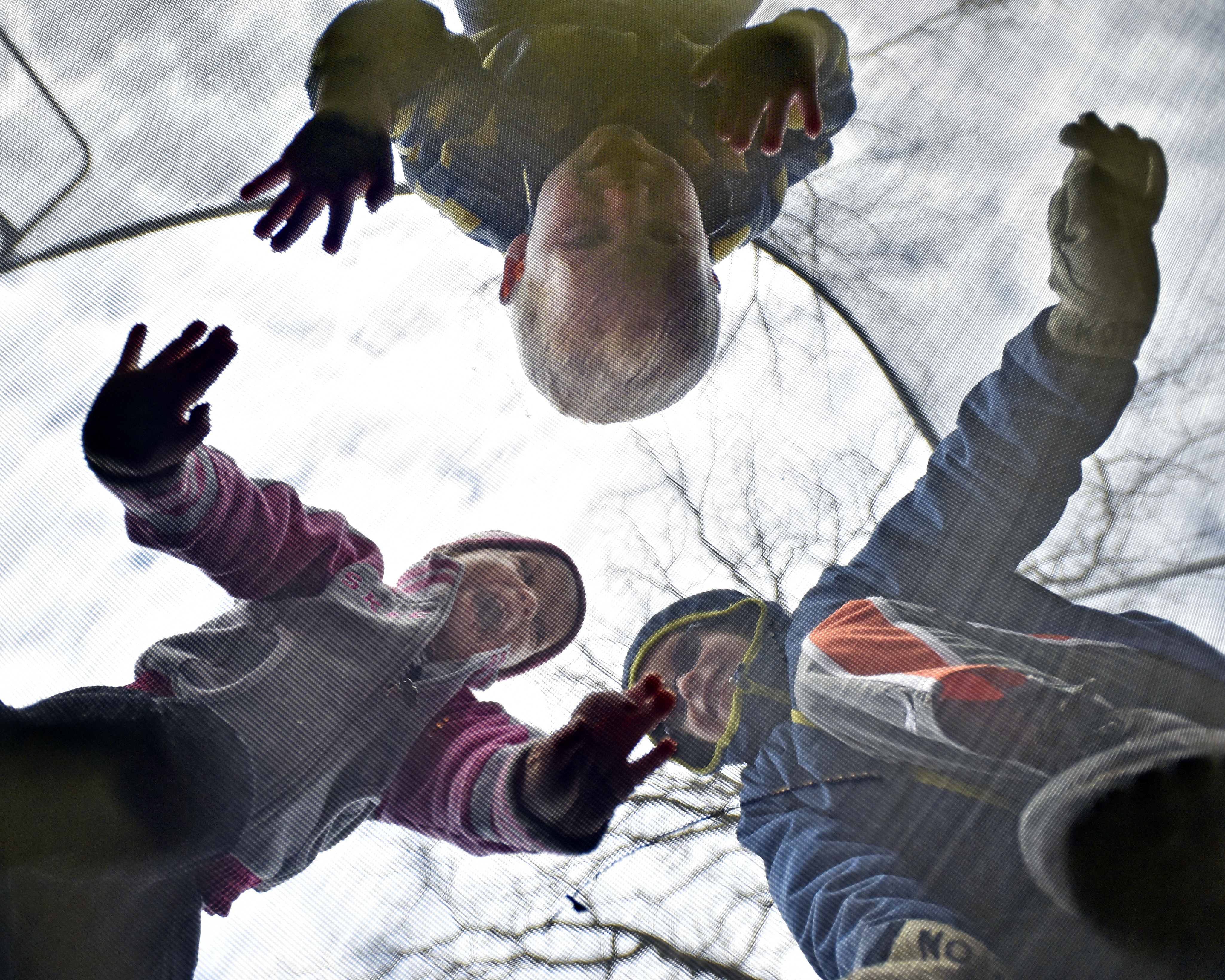 Kolton Montague, right, 5, jumps on a trampoline in the backyard of his home in Avon, N.Y., with his  siblings Kellan, top, and Kaelyn, left, both 2, on Nov. 16, 2014.