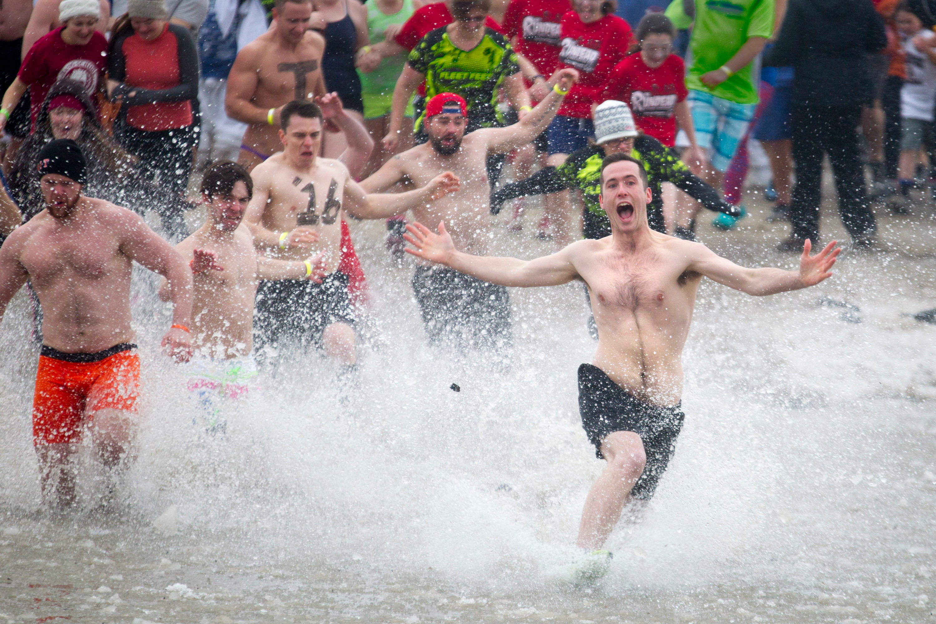 Plungers jump into the icy water during the Rochester Polar Bear Plunge at Charlotte Beach in Rochester, New York on February 8, 2015.  Hundreds attended the event to raise money for the Special Olympics.