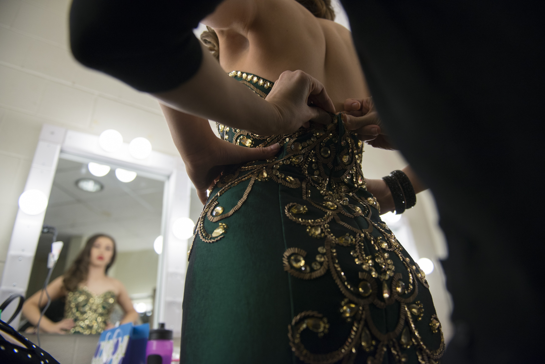 Marivi Howell-Arza gets zipped into her dress at the Miss Flower City Beauty Pageant. A pageant that is a preliminary round for the young woman to become Miss New York and then hopefully Miss America on January 31, 2015.