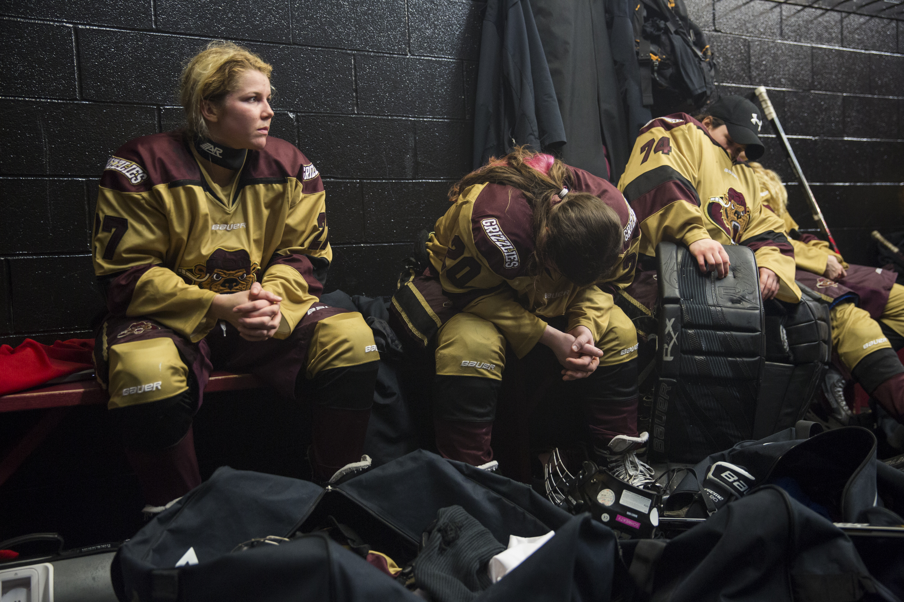 (From left) Shanley and her teammates, Lexi Firkins and Serena Angelo rest during half time after the second period of their first game against Troy-Albany on March 6, 2015. The Rochester Grizzlies were losing 0-1 at the end of the second period and came back to win the game 2-1 in a shootout.